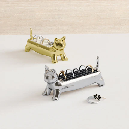 A Brass Ali Cat Ring Holder and a Chrome Ali Cat Ring Holder, each with rings in the slots. (Copy)