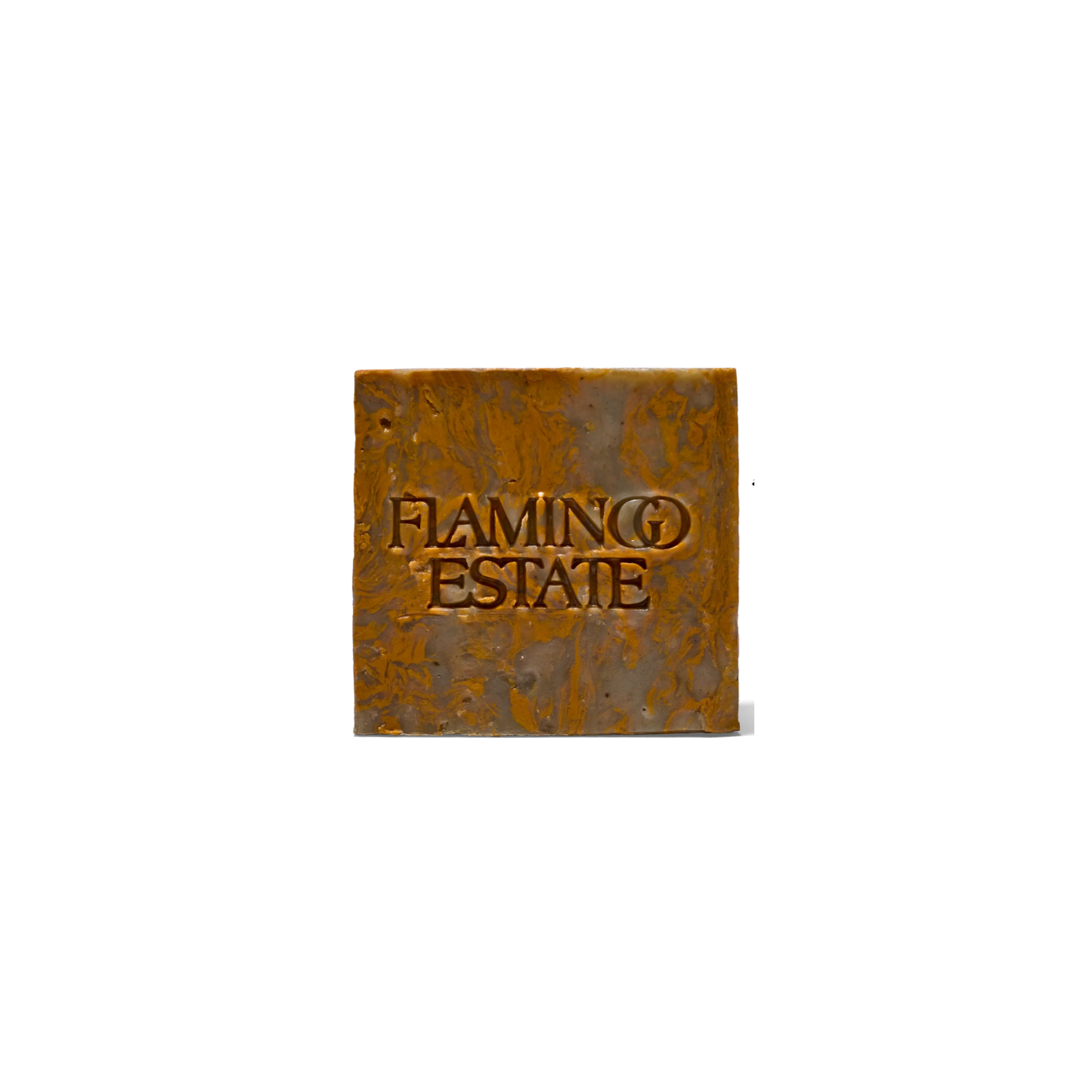 Flamingo Estate Green Goddess Soap Brick, a marbled rust colored square soap with "FLAMINGO ESTATE" indented into it.