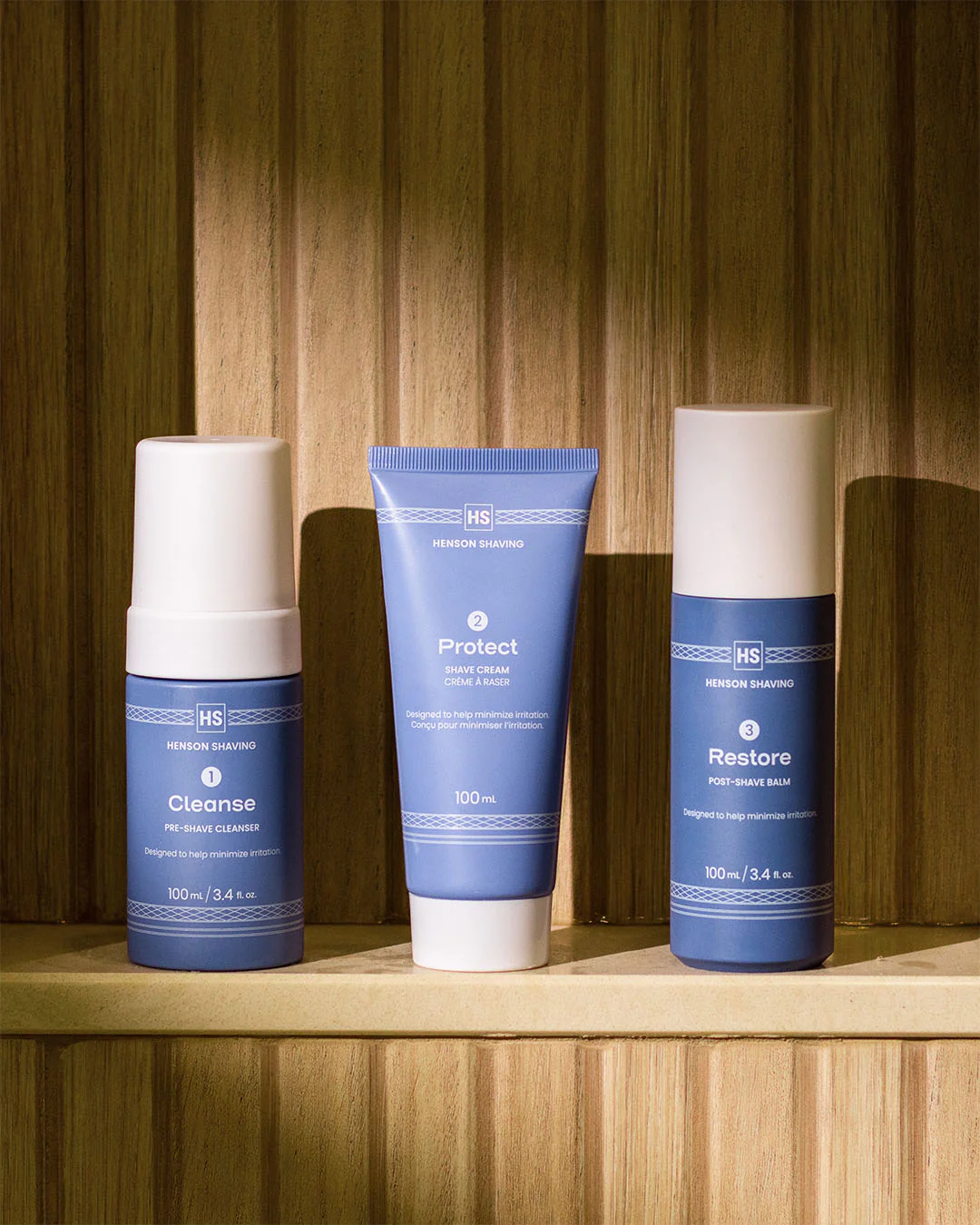 Three products included in the Henson 3-Step Shave Routine kit on a shelf..png