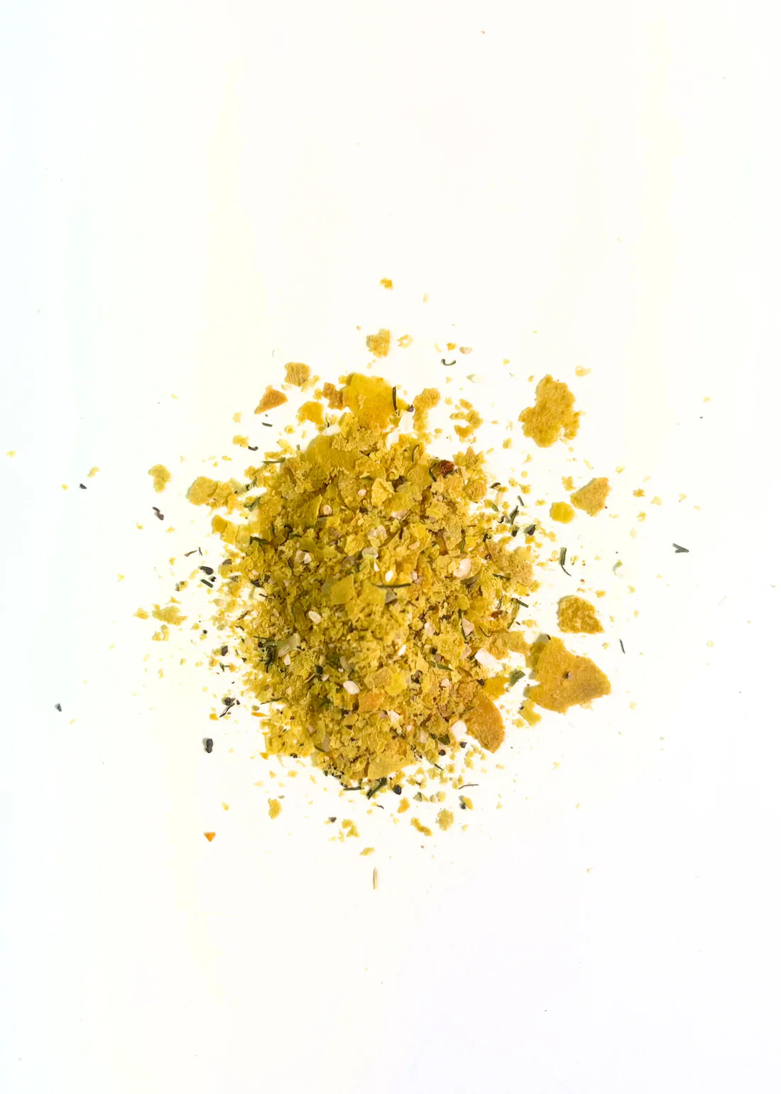 Nutritional yeast, onion powder, garlic, ad other spices in a small mound.