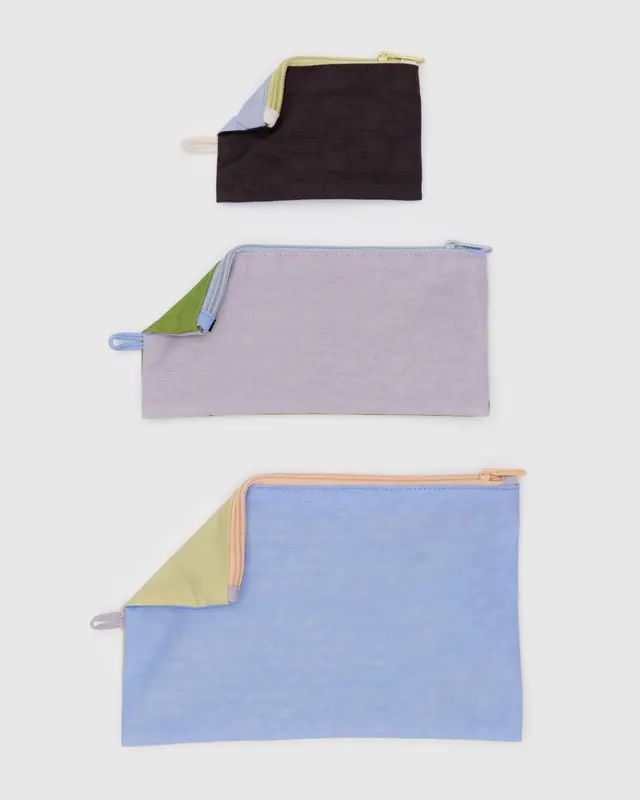 Set of three different sized Baggu Flat Pouches in a pastels colorblocked motif, in blue, lavender and yellow.