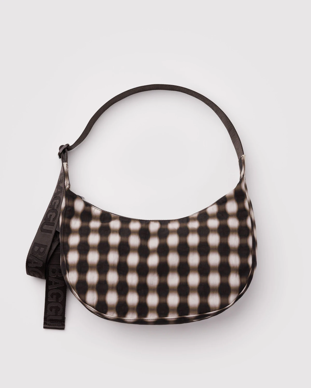 Baggu Crescent Bag in blurred gingham nylon with a blrred gingham nylon strap on a white background.