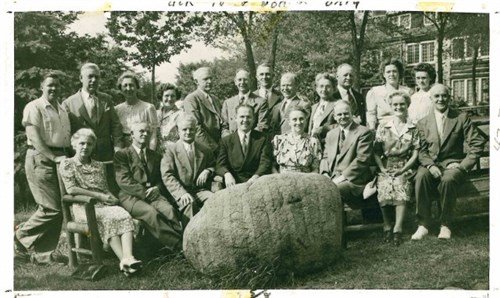 Photo of group around the sacred Rock Rock as if it is their mascot