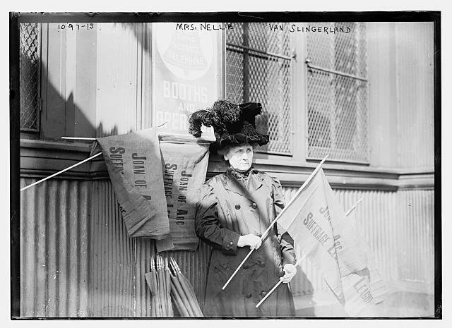 Nellie holding suffrage banner .jpeg