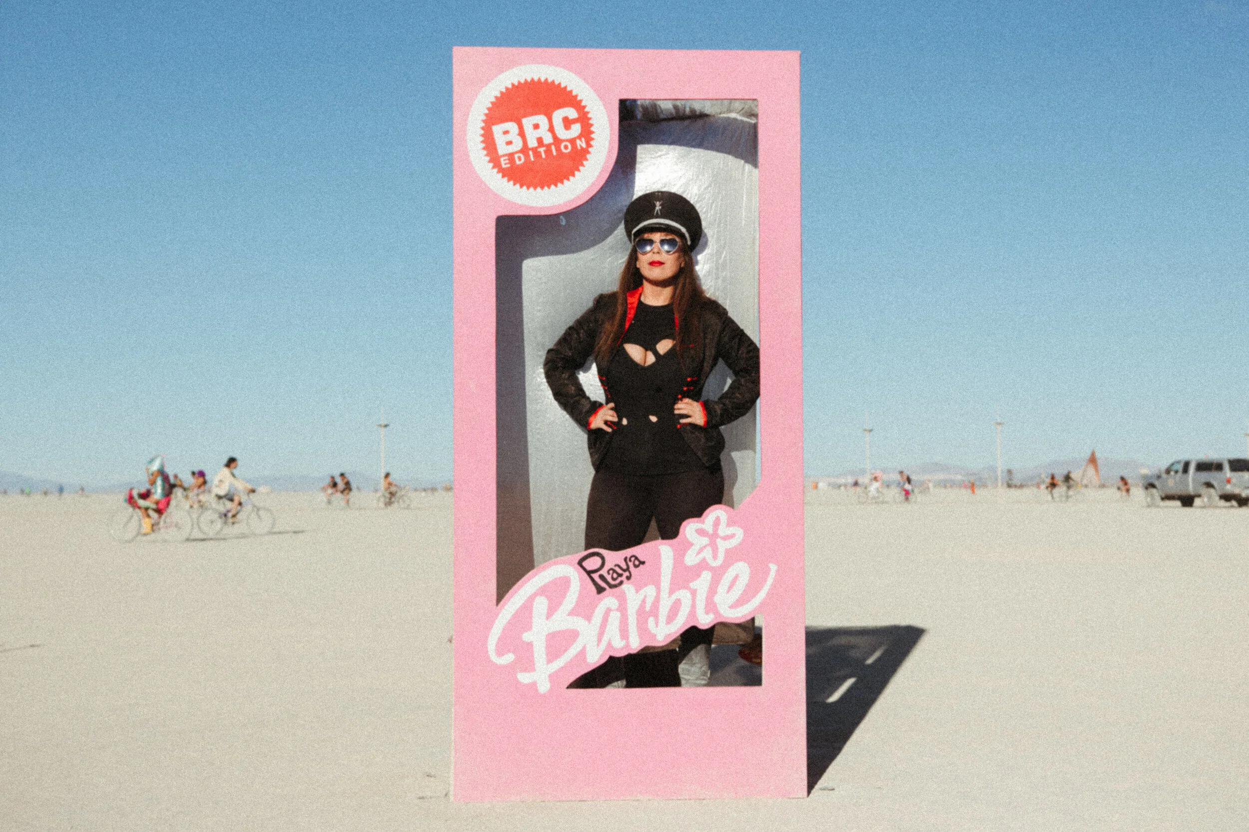 ANDREA VODICKOVA at Burning Man standing in a life size Barbie box