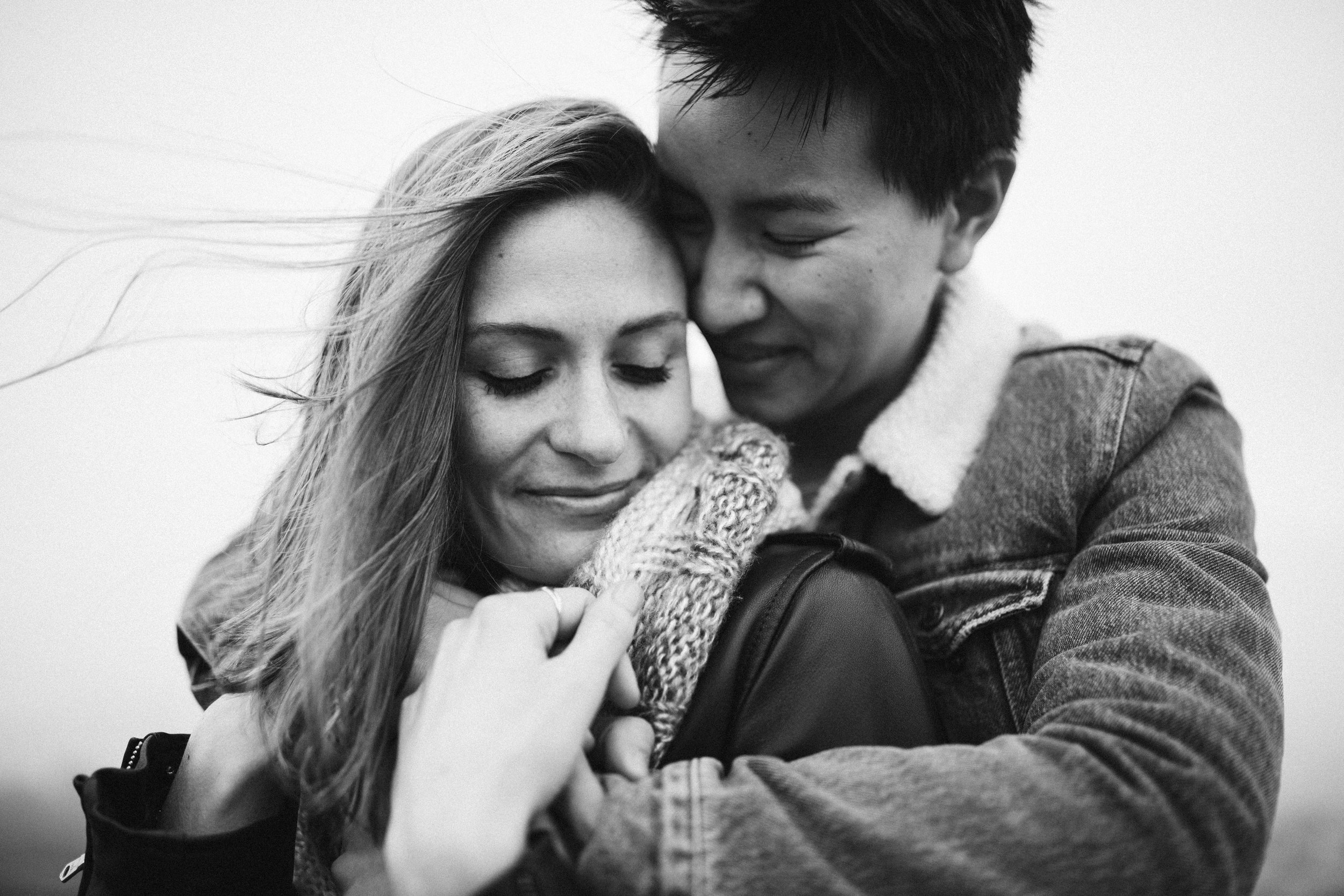 black and white photo of a couple hugging each other during their engagement session in San Francisco