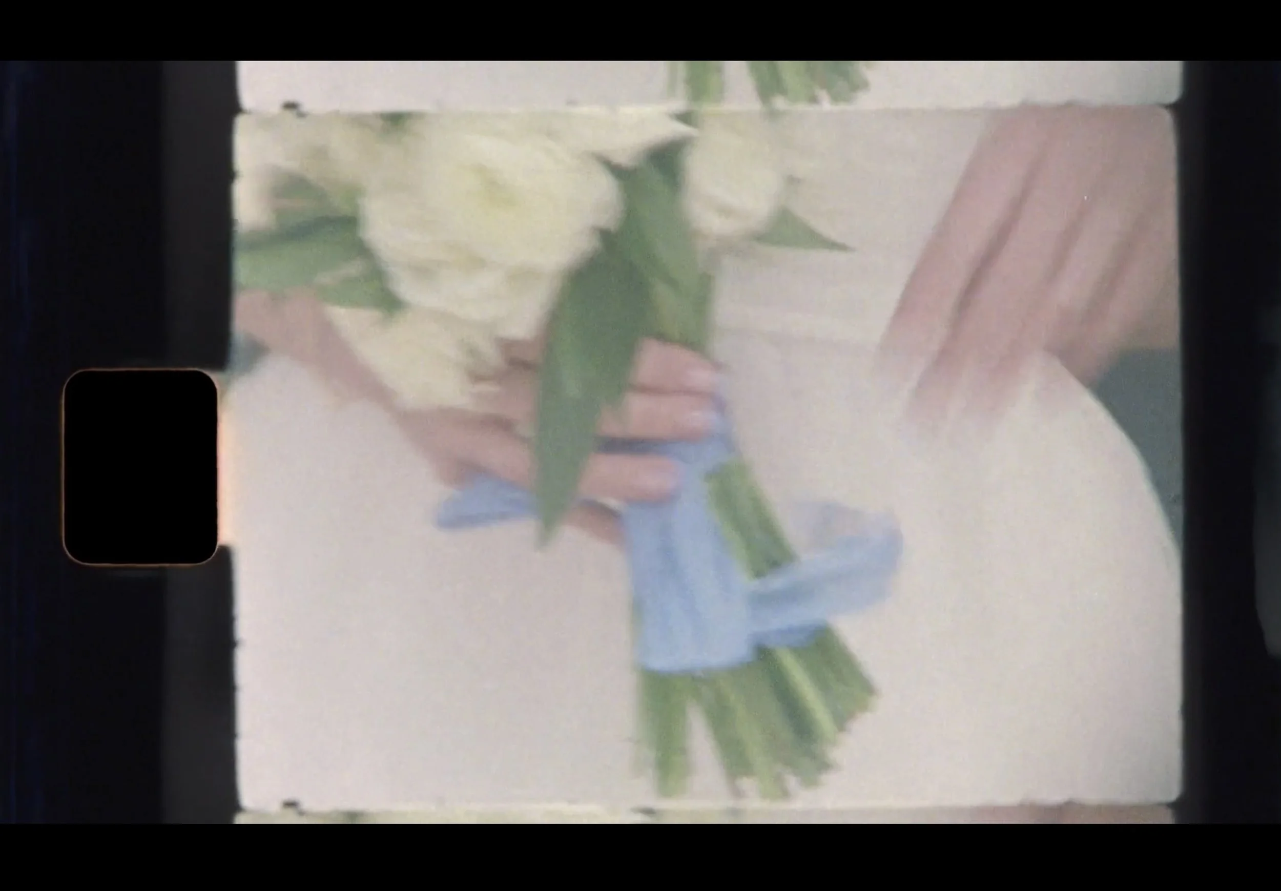 super 8 screenshot of detail of bridal bouquet at San Francisco city hall