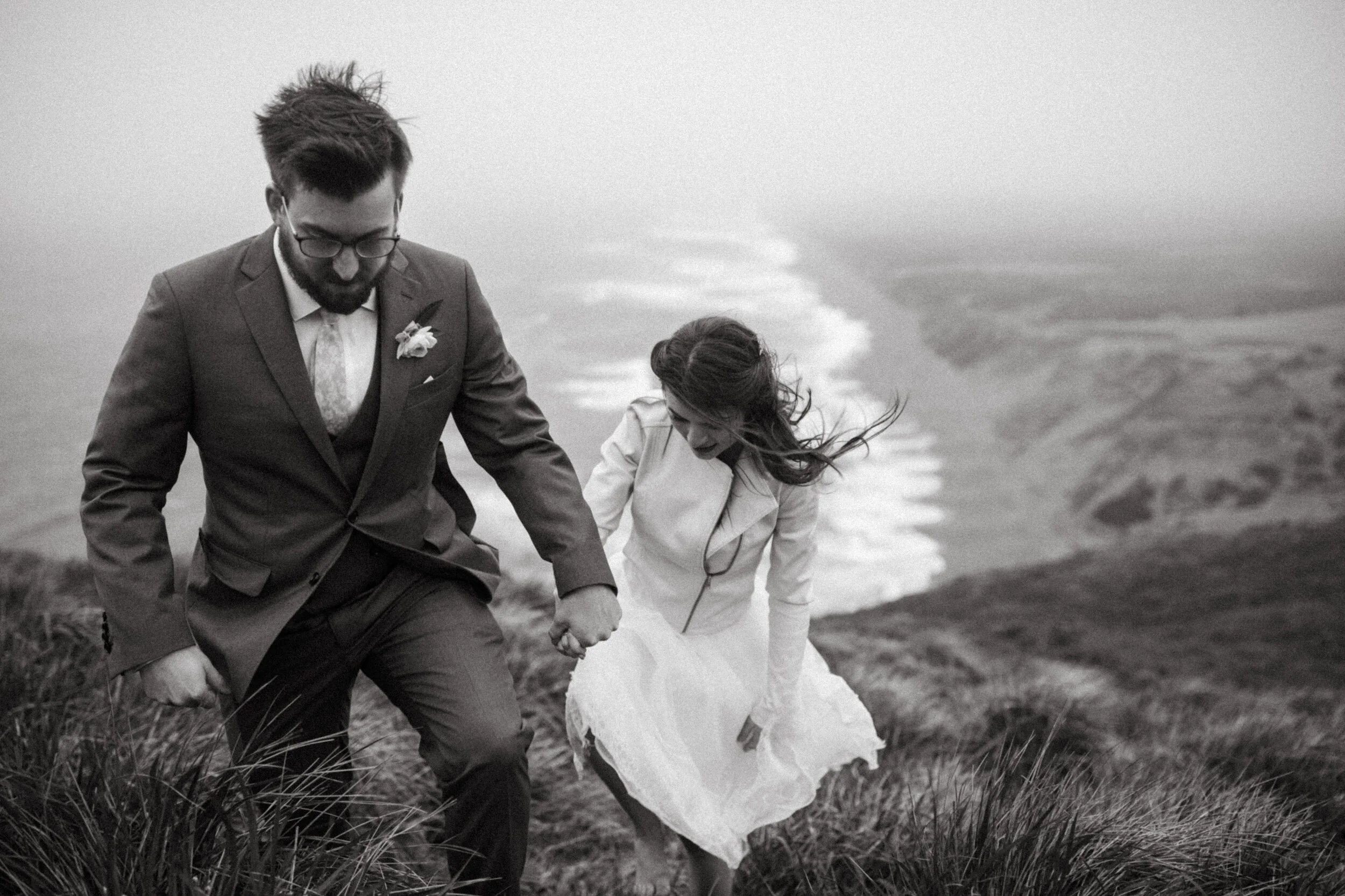 elopement couple walking in a field in Point Reyes 10 reasons to elope by Andrea Vodickova