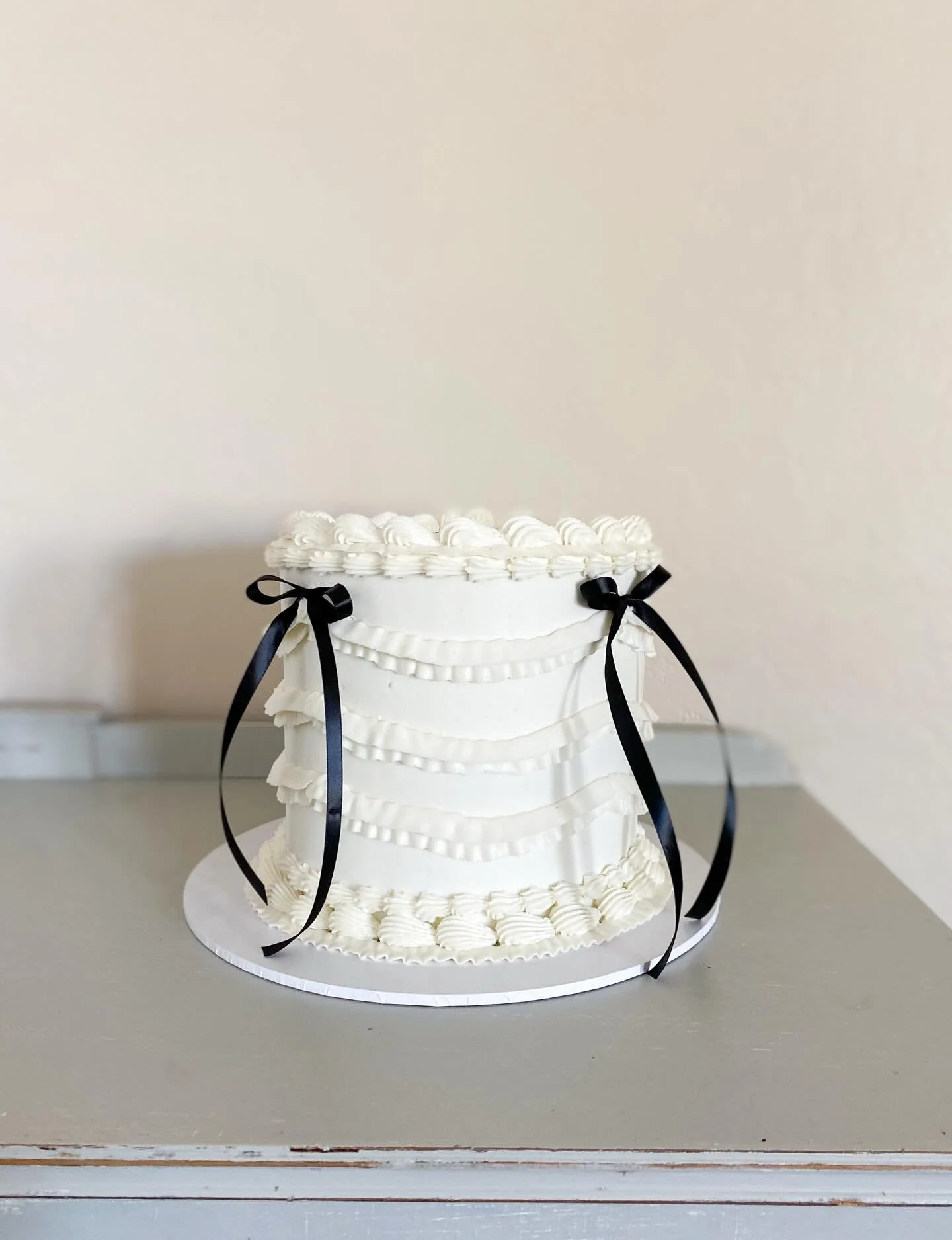 Extra Ruffle-y Bow cake. 🖤
Black bow cake No. 2 for the week! 

8&rdquo; Classic Cake | Vanilla bean cake layers, filled with strawberry compote, and frosted in a brown butter buttercream (inside) and vanilla bean buttercream (outside).