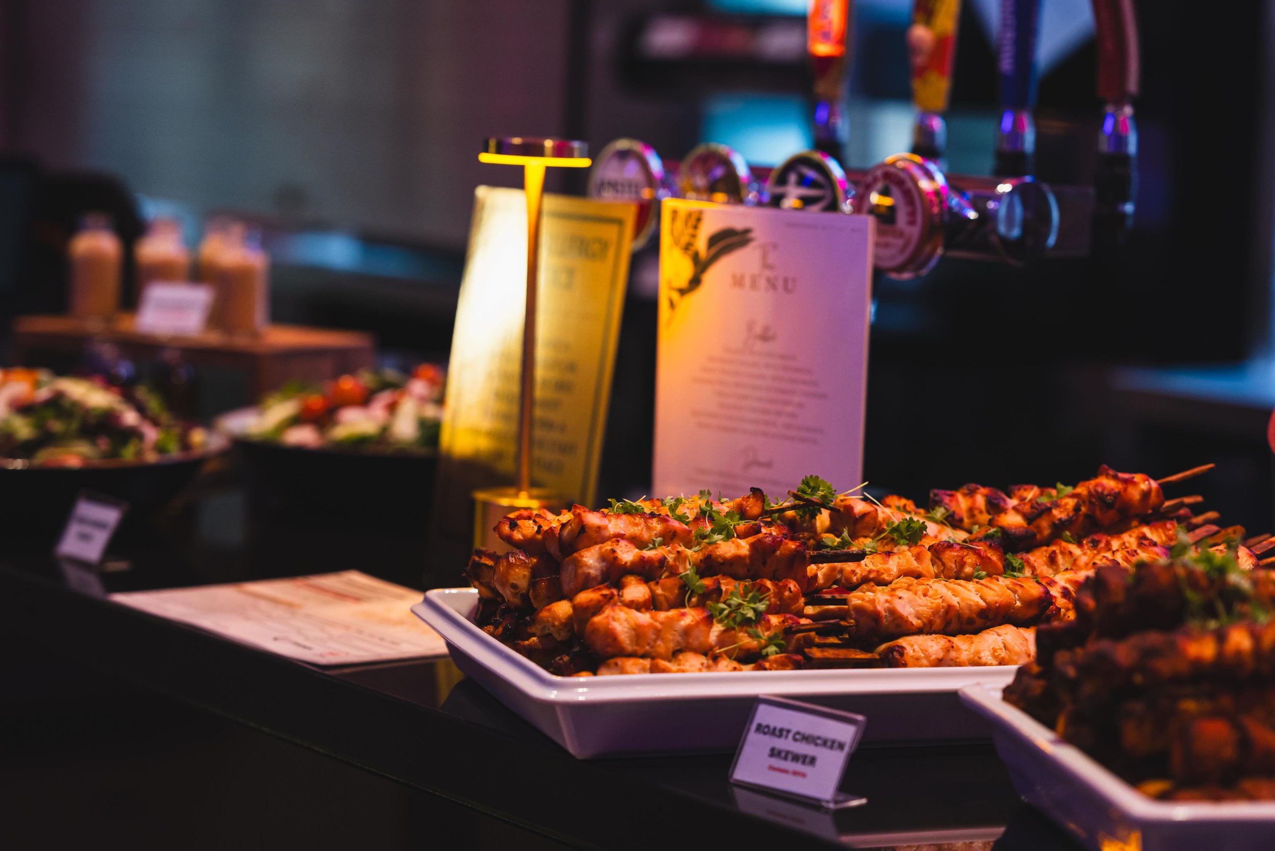 The main event. Moving down the line to where the real flavor is perfectly grilled roast chicken skewers, beautifully charred and garnished. When photographing food, my goal is always to make you feel like you can taste the texture right through the 