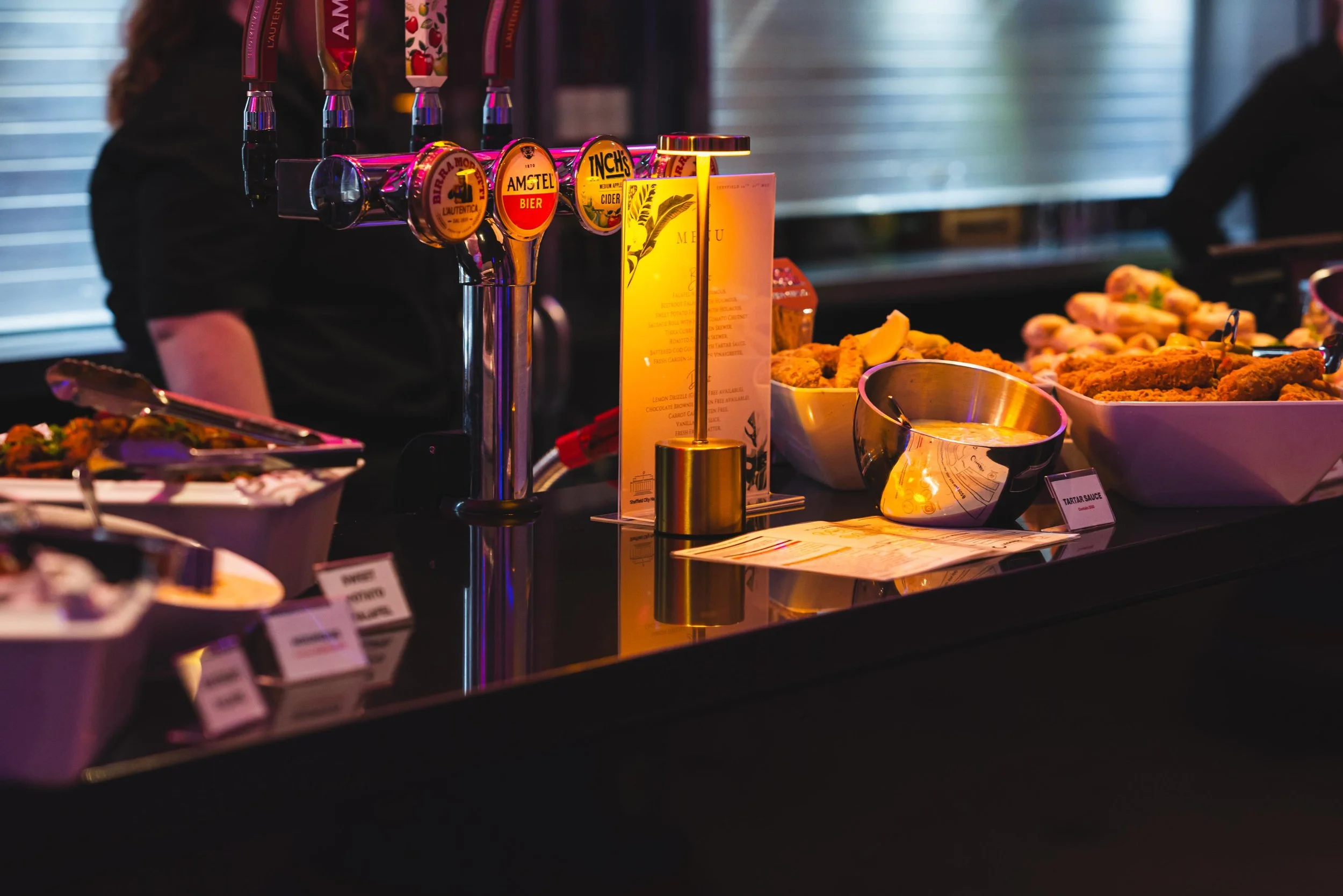 Atmosphere is everything. Starting the event off right with a beautifully curated buffet spread under the ambient glow of the bar. It&rsquo;s all about creating an experience the moment guests walk into the room where the lighting hits the details ju