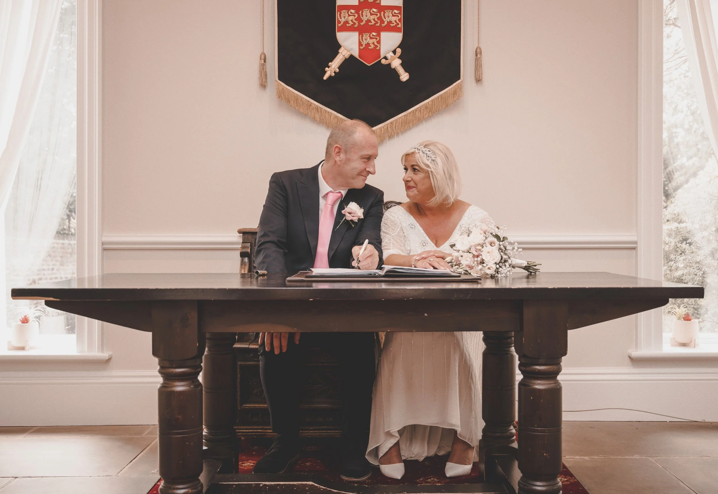 The beginning of forever, beautifully written in ink. 

There is something incredibly moving about this exact moment. The deep breaths, the shared smiles, and the official step into a brand new chapter. Watching these two seal their commitment surrou