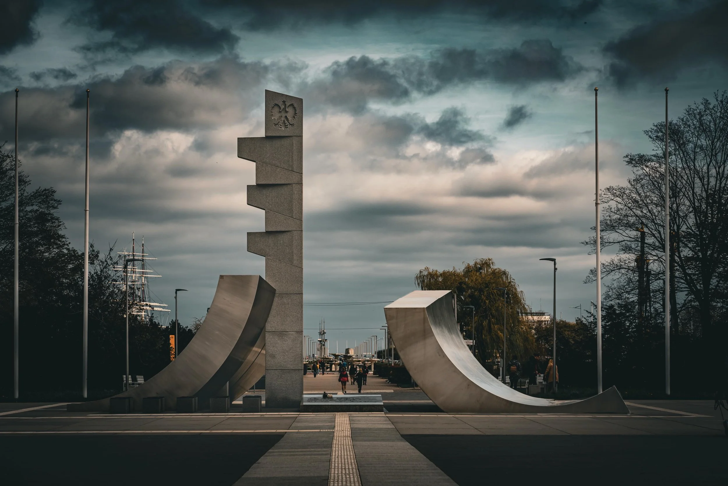A powerful tribute to resilience. Framing the Monument to the Polish Navy (Pomnik Polskiej Marynarki Wojennej). The sharp, geometric lines of stone and steel cutting into the dramatic Baltic sky create a powerful and reflective atmosphere.

Capturing