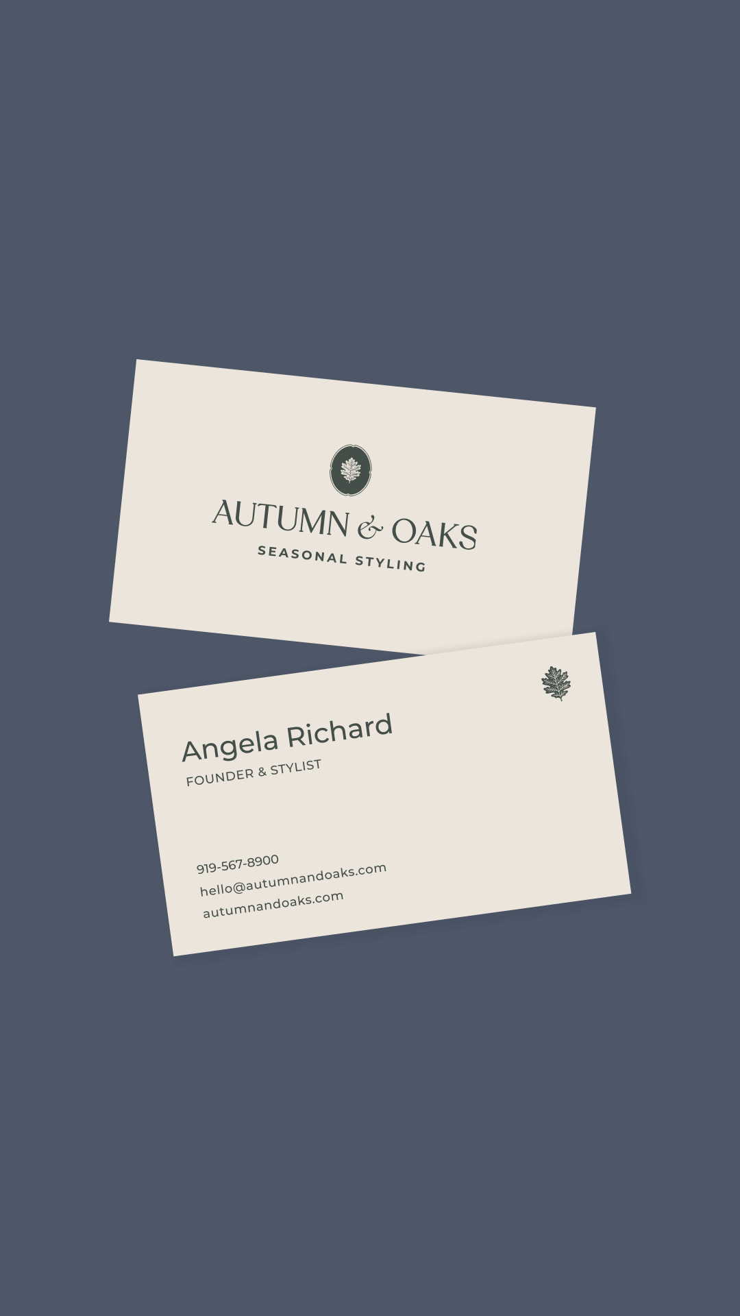 Two business cards on a dark blue background. The top card displays "Autumn & Oaks, Seasonal Styling" with a leaf logo. The bottom card shows "Angela Richard, Founder & Stylist," with contact details.
