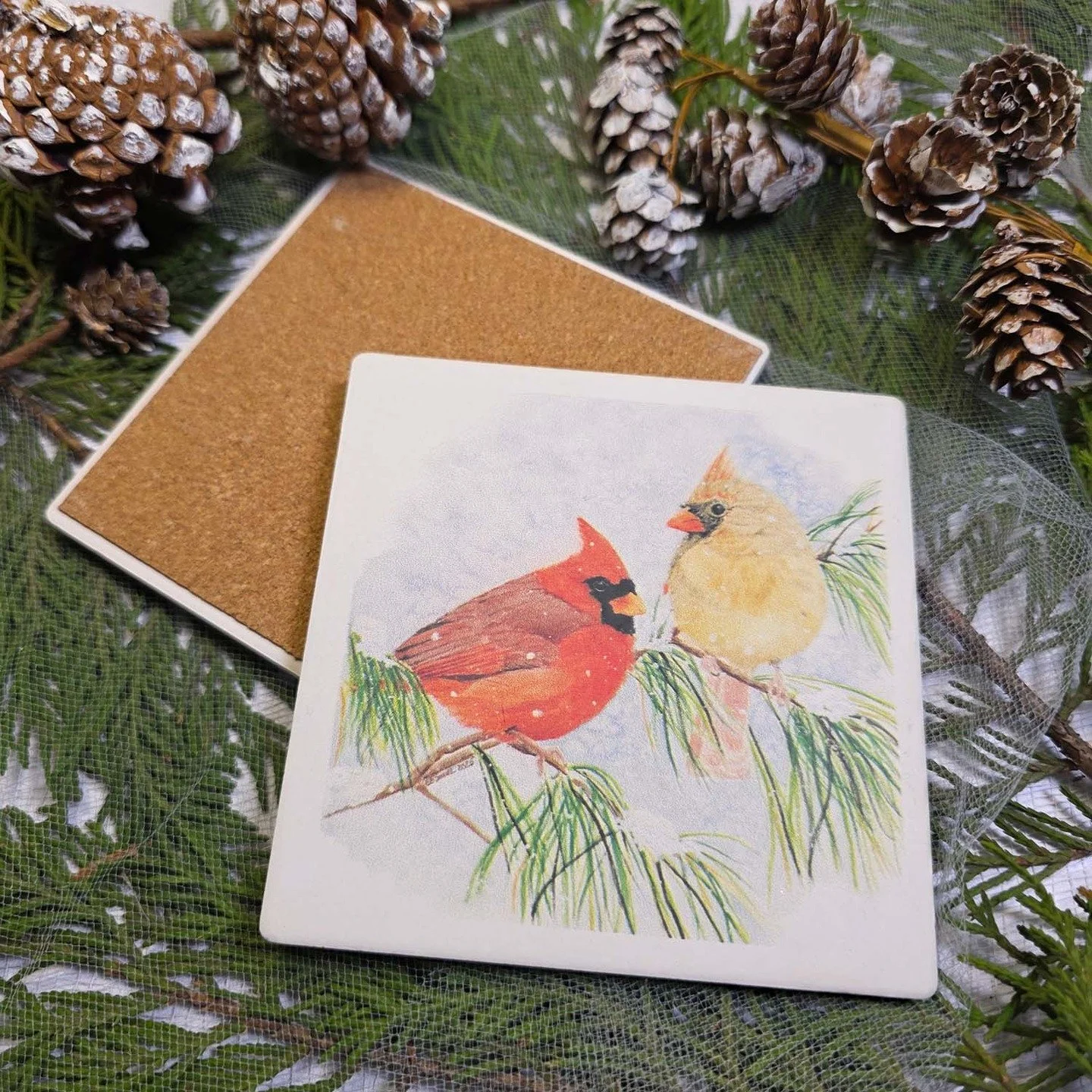 The next preview for the Holiday Shop (coming at the end of October) is this year's coaster design! The &quot;Evergreen Connection&quot; painting with a pair of cardinals perched on snowy evergreen branches has been printed onto thirsty stone coaster
