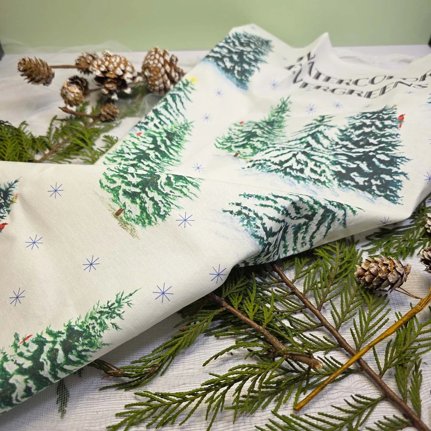 And our next coming soon holiday goodie is the Watercolor Evergreen tea towel! This towel design was created from my 3 evergreen paintings with blue snow flakes quietly falling around the trees. This a stunning, 100% cotton, lint-free, thirsty tea to