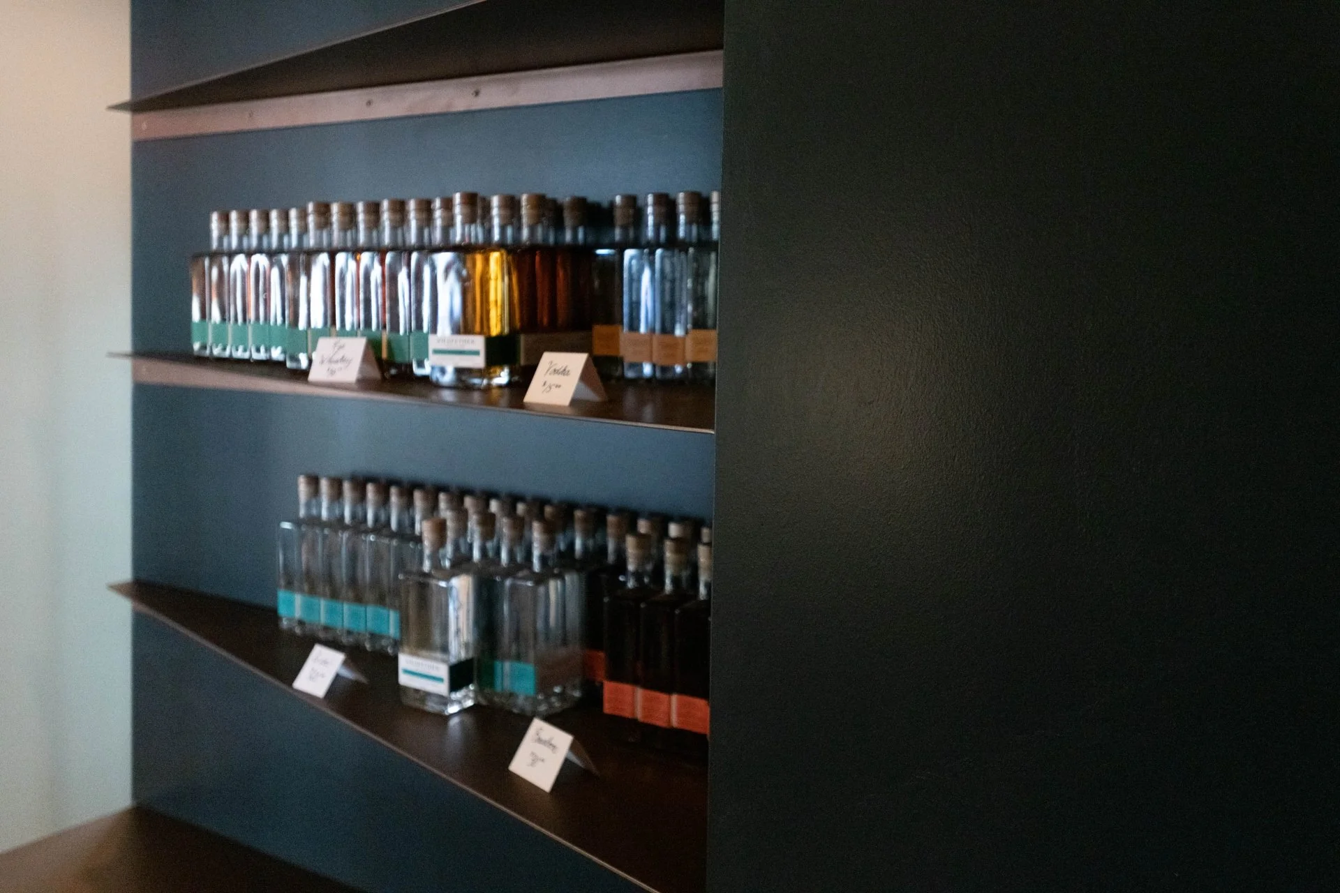 Custom furniture and features designed for Wildfether Distillery in Haddonfield, NJ, by Coop Forge Mobile, a partnership between Benita Cooper Design and Timber Forge Woodworks.