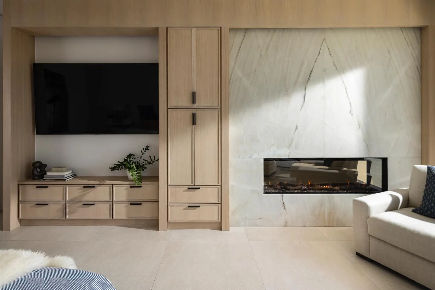 This primary bedroom was designed as a sanctuary for our clients to enjoy a book by the beautifully bookmatched stone fireplace, snuggle up for a movie in bed or a quiet retreat to recharge. 

The stunning ocean view provides the perfect morning sunr