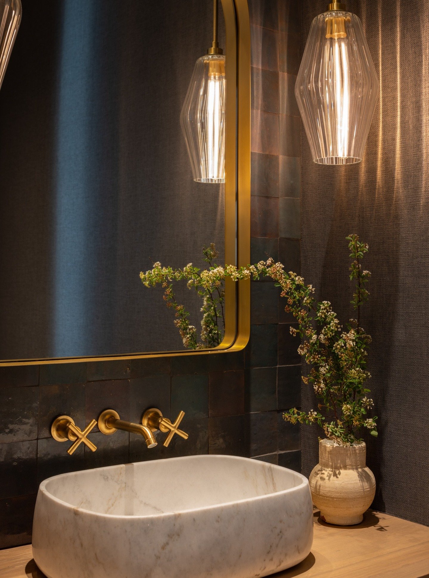 Sometimes the smallest rooms make the biggest impact!

From grasscloth wallcovering to hand painted tiles and a carved stone sink, we wanted to embrace natural materials and also make a statement for guests in our clients powder bath. We love how all