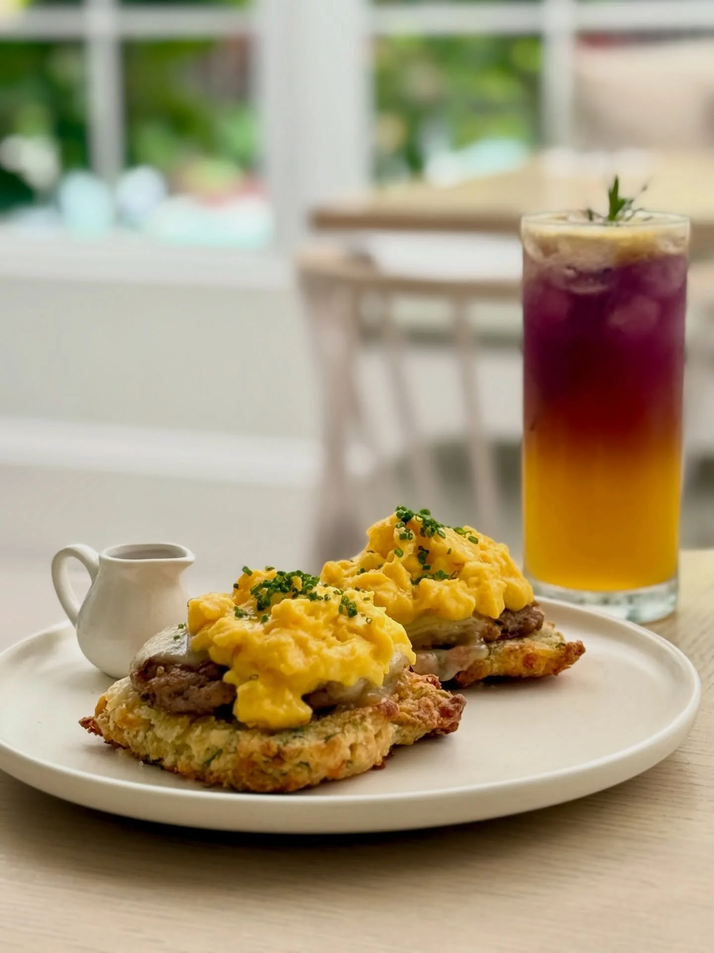 Soft eggs, golden biscuits, and sunshine. The kind of comfort only breakfast brings ☀️

☝️Our scallion cheddar biscuits with house-made sausage, cheese, and scrambled eggs, drizzled with smoky chili maple syrup.  The breakfast plate that hits every c