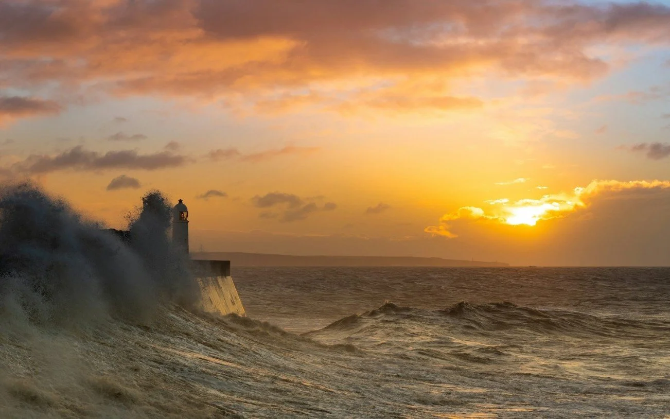 lighthouse rough sea and sun.jpg