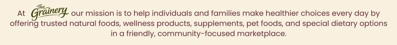 Close-up of a sign with the logo of The Grainery and a mission statement about offering natural foods, wellness products, supplements, pet foods, and dietary options in a community marketplace.