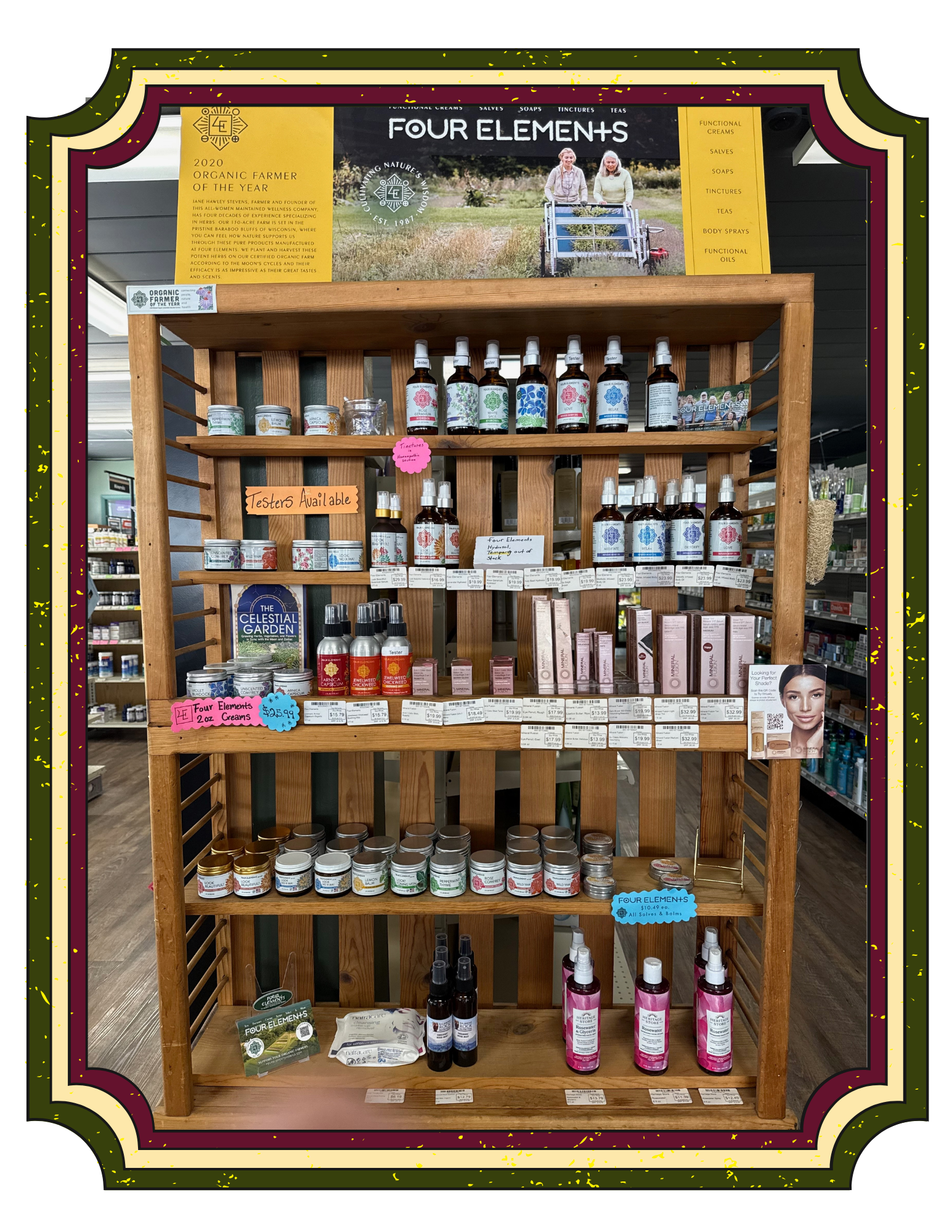 Display of Four Elements brand wellness and skincare products on a wooden shelf, with signage, product labels, and promotional materials in a retail store.
