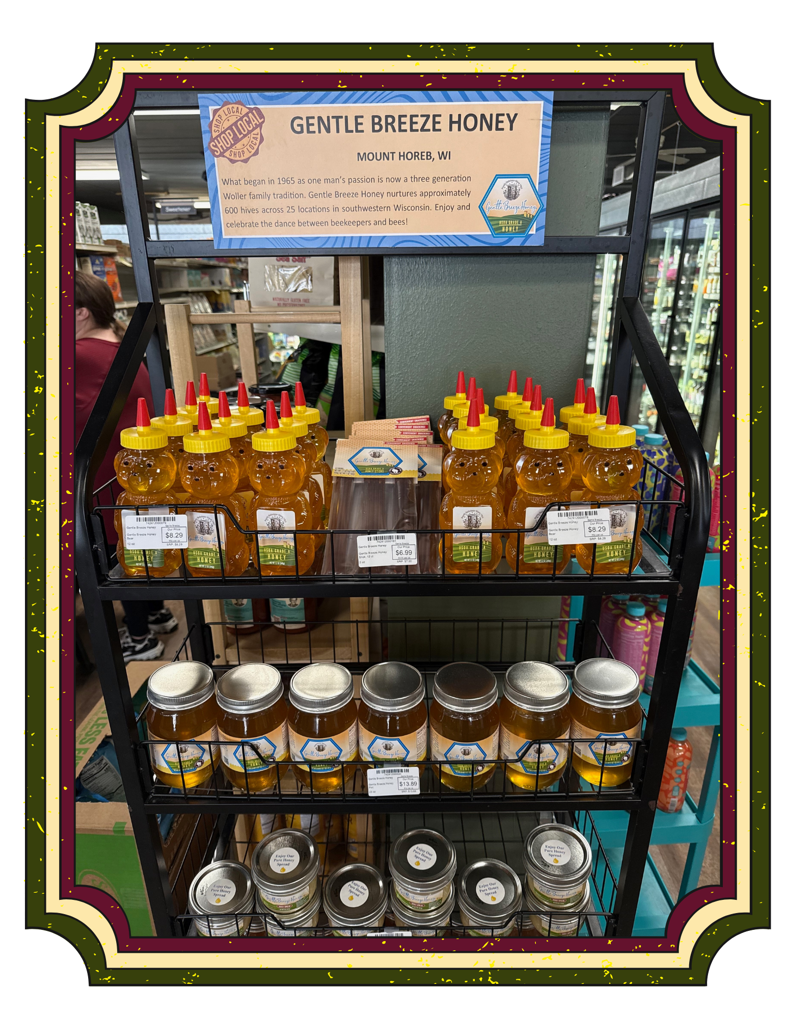 Display of honey bottles and jars with a sign about gentle breeze honey from Mount Horeb, Wisconsin.