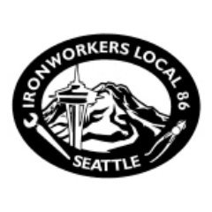 Black circular logo with white border. Text reads 'IRONWORKERS LOCAL 86' and 'SEATTLE'. Contains an illustration of the Space Needle, Mount Rainier, and a worker with a hammer.