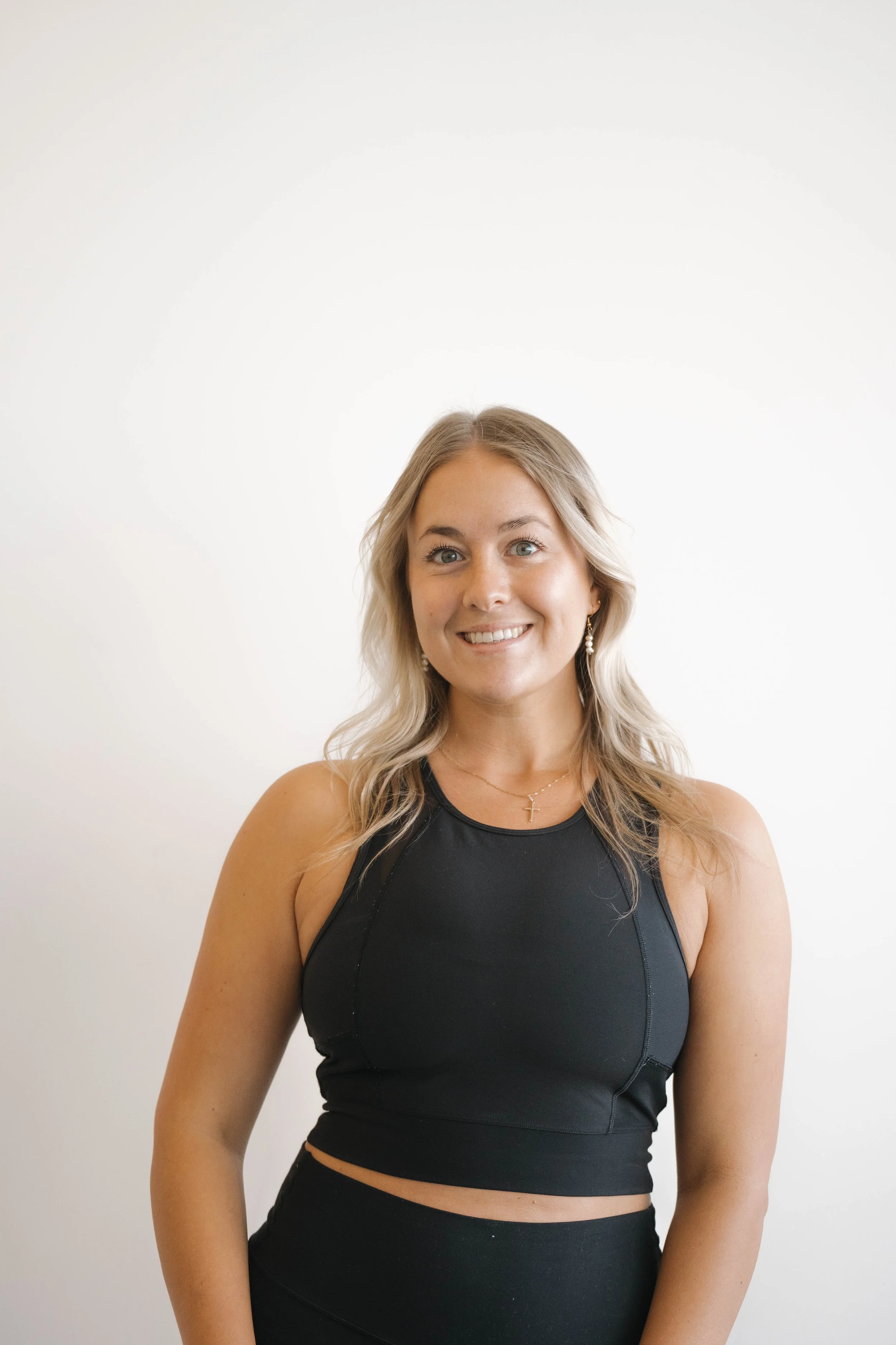 Women wearing black sports bra with "VIVE" in white letters