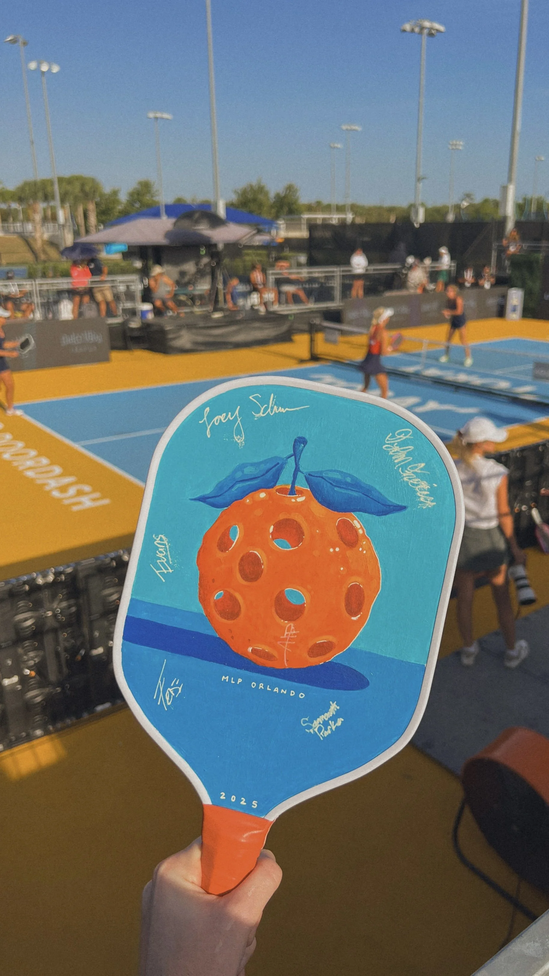 Custom painted pickleball paddle inspired by Major League Pickleball - Orlando. Signed by Orlando Squeeze pro players