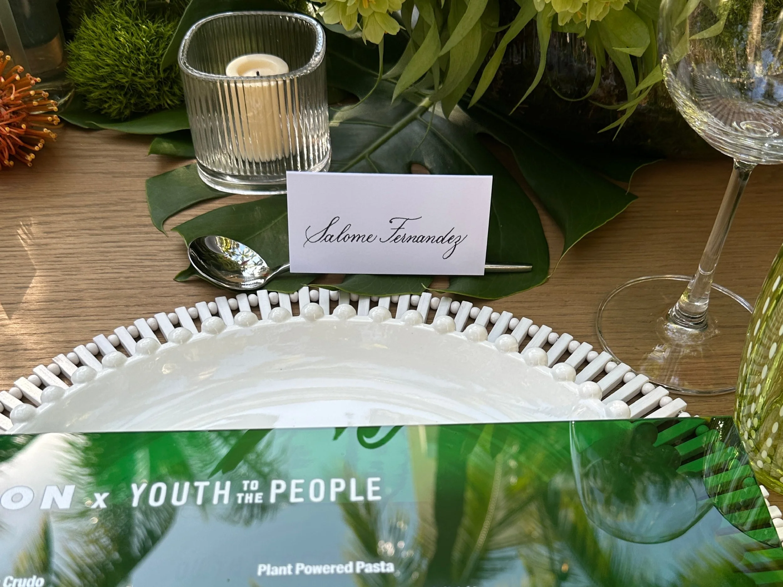 White place card with black text written by Miami Calligrapher Sanique