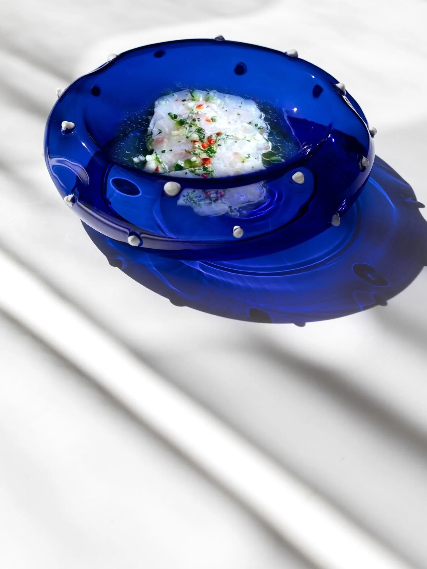 Salgados III Ocean Blue, the deepest tone of the collection. Available through the online store.🌊

Photography by @adalberto_duarte.ph 
Food image Wild sea bass crudo with cucumber, chili, and lime from oma.london
Art Direction &amp; Image Compositi