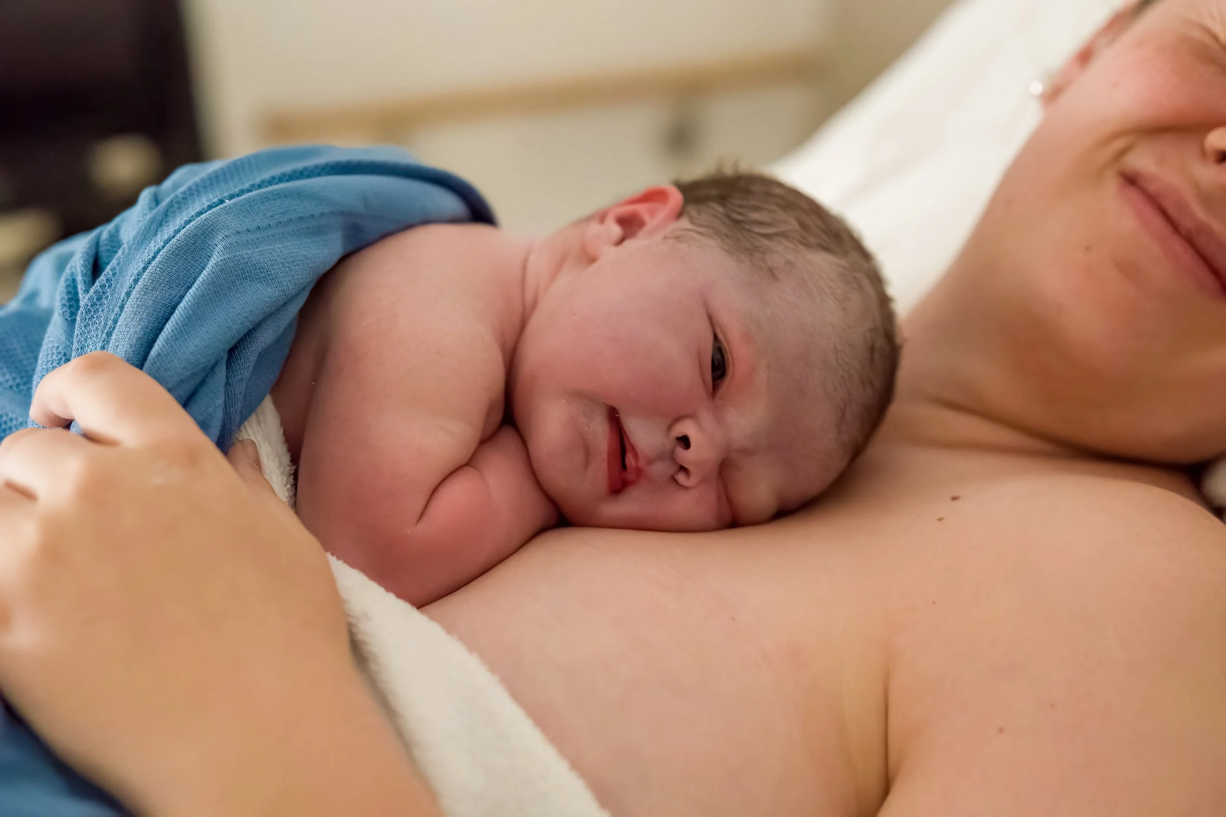 a newborn baby on her mum chest after birth