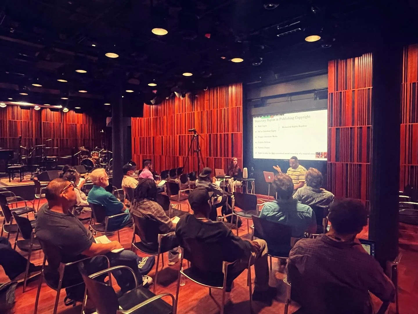 Audience members attend a Crescendo music business workshop in the New Orleans Jazz Museum performance room.