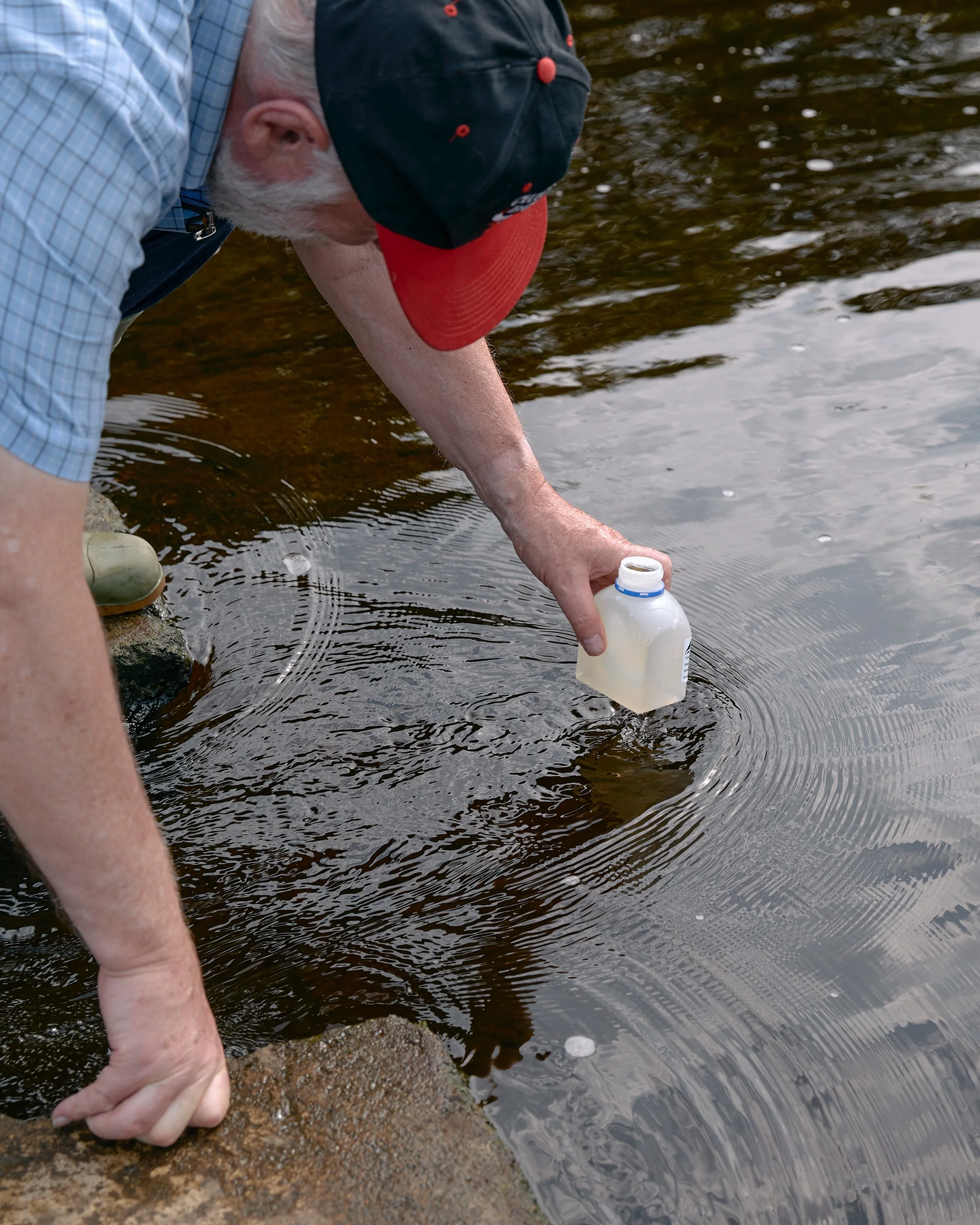 A citizen scientist collecting water samples from the River Wharfe in Wharfedale.