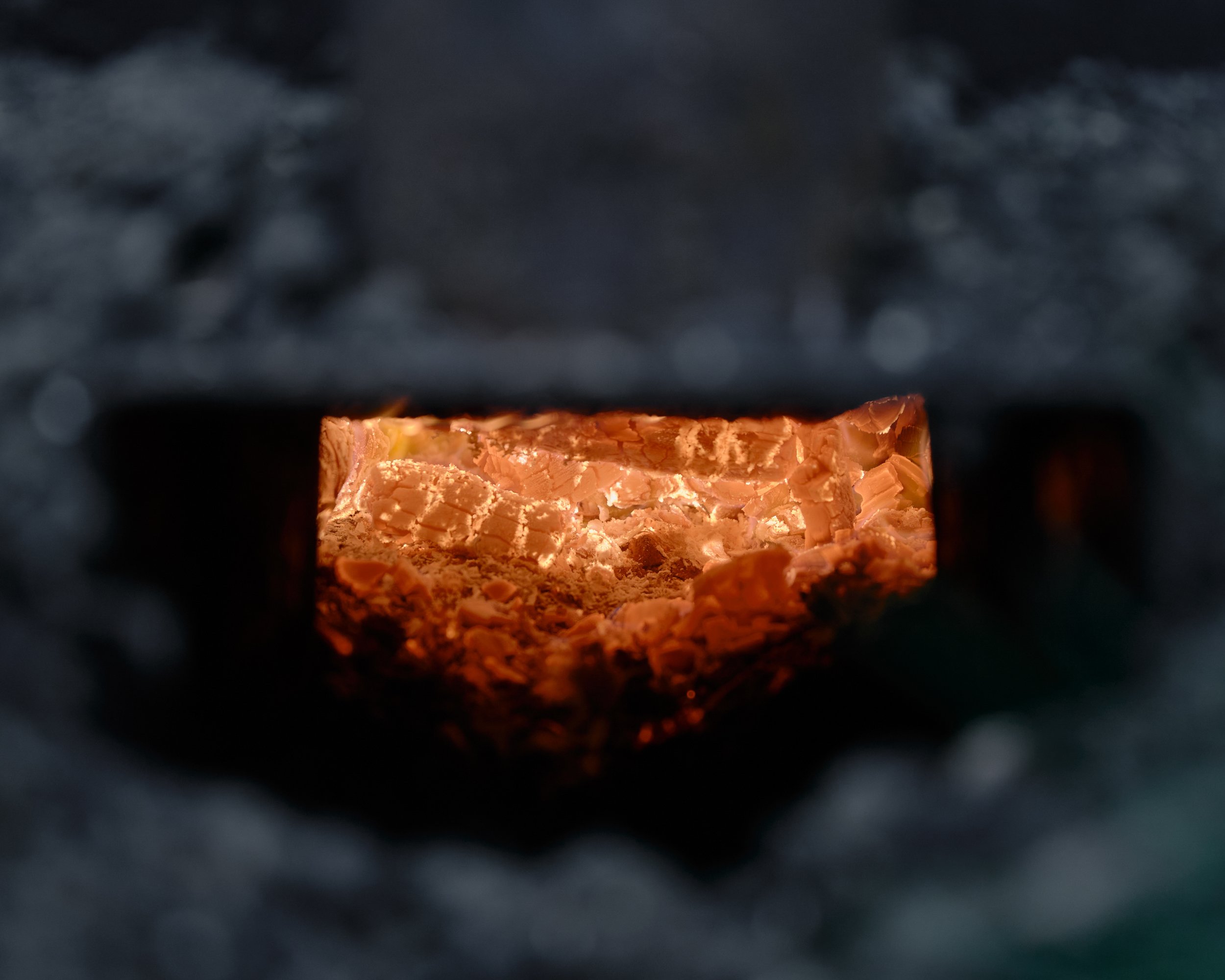 Burning wood glowing inside a charcoal kiln in Yorkshire, England.
