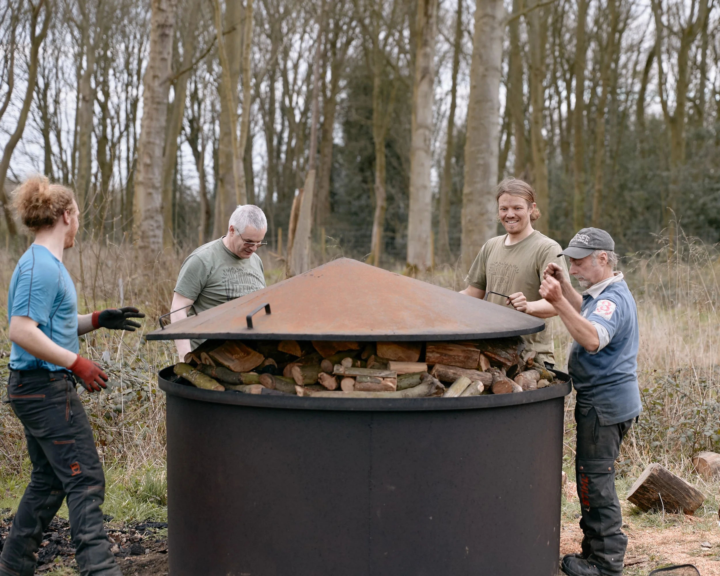 Coppice workers preparing wood for charcoal production in Yorkshire, England.