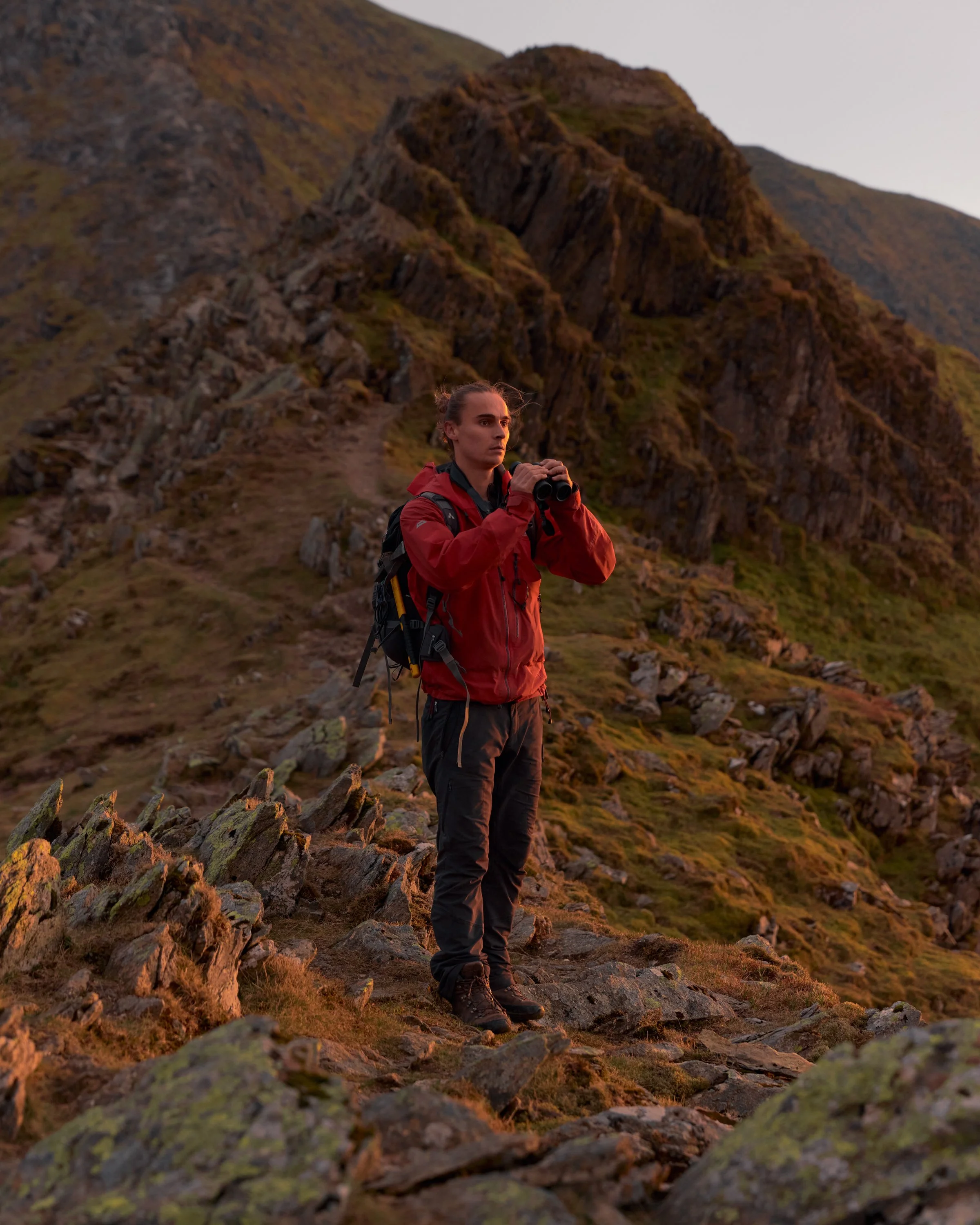An ecologist stands on a mountain in the Lake District, Cumbria, England.