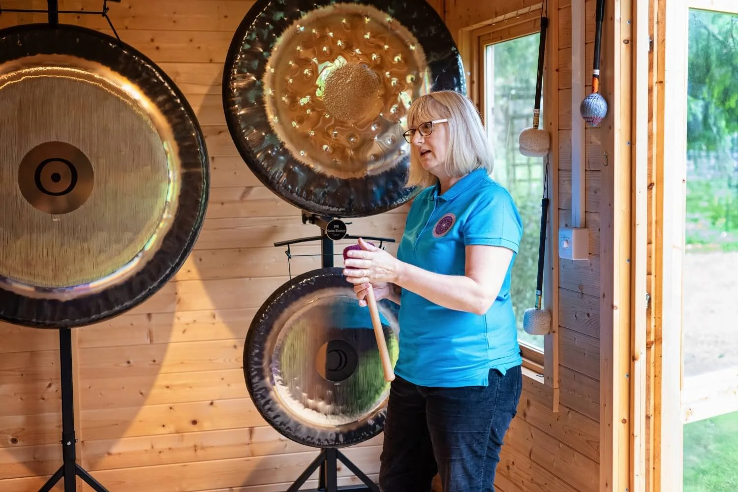 Sound therapy tutor Helen Campbell looking animated and passionate while teaching an intimate private course inside the Stretton timber cabin sanctuary.