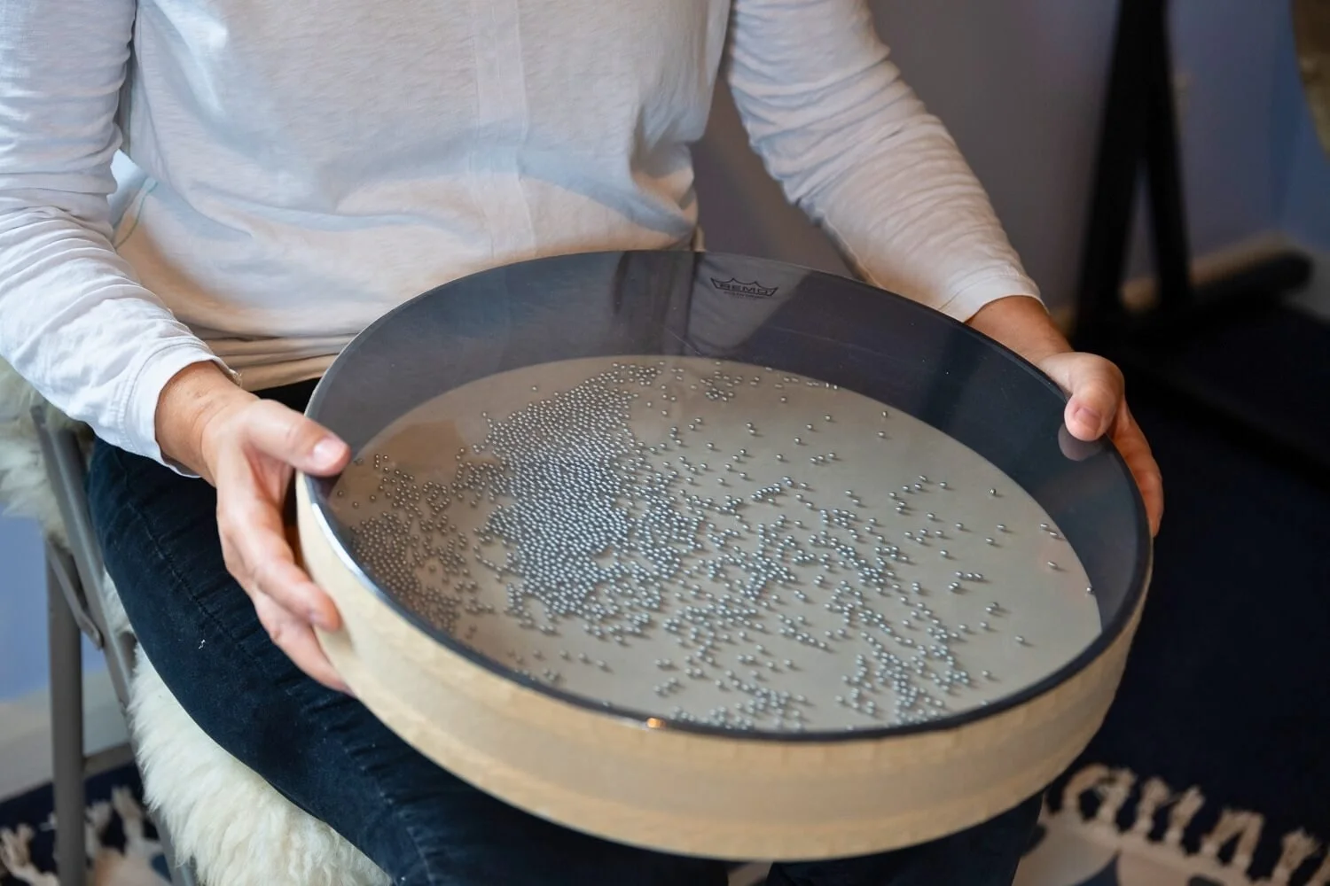 Academy founder Helen Campbell demonstrating fluid ocean drum sound therapy techniques to mimic the soothing frequency of water waves during a hands-on training module near Grantham.