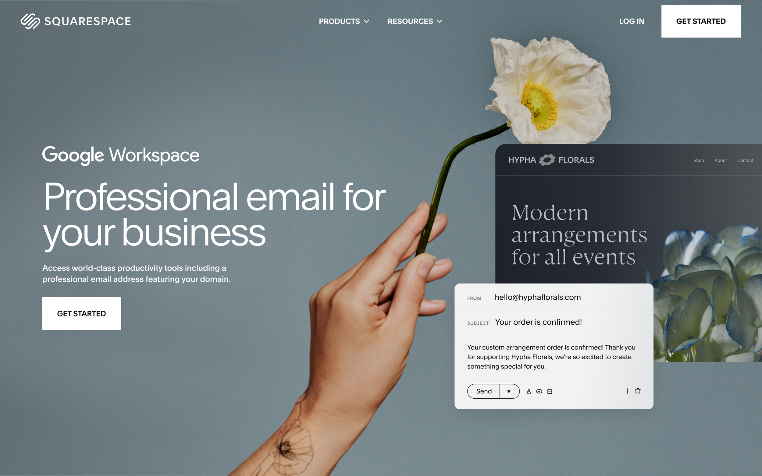 A person holding a white and yellow flower with a tattooed wrist in front of a website displaying a professional email service for businesses.