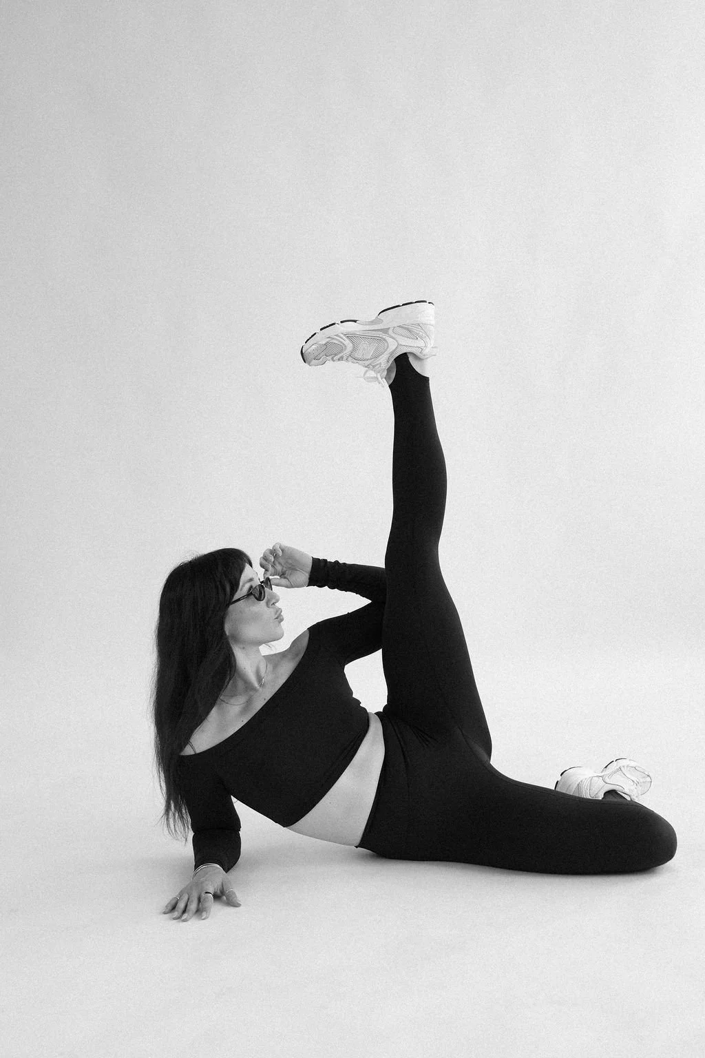 Elena Lee, nutrition coach for women, playfully poses in the studio at her brand photoshoot.