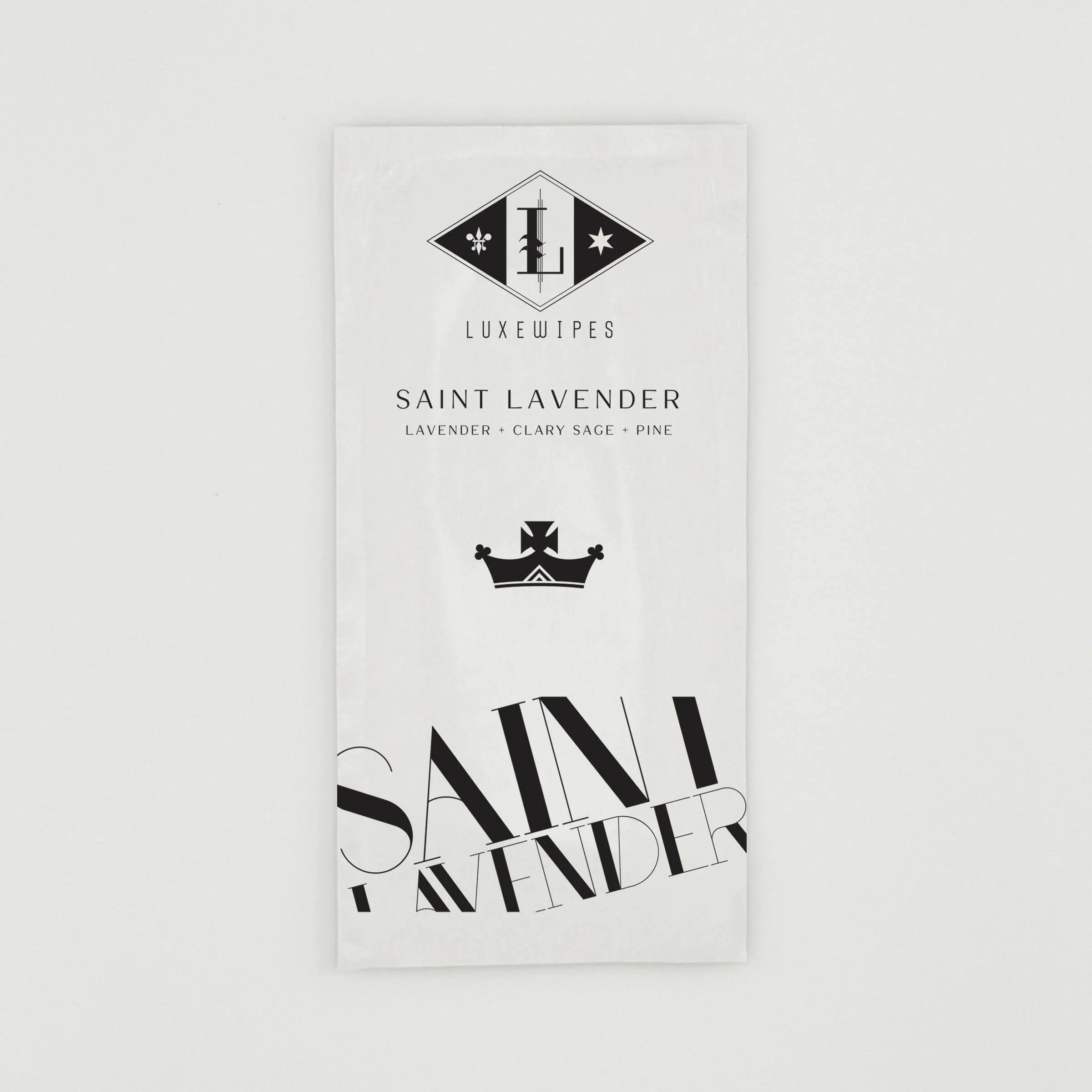 An individually wrapped LUXEWIPES Saint Lavender sachet, illustrating the premium, on-the-go aromatic hand and face wipe option to include in your curated Fragrance Palette Trio.
