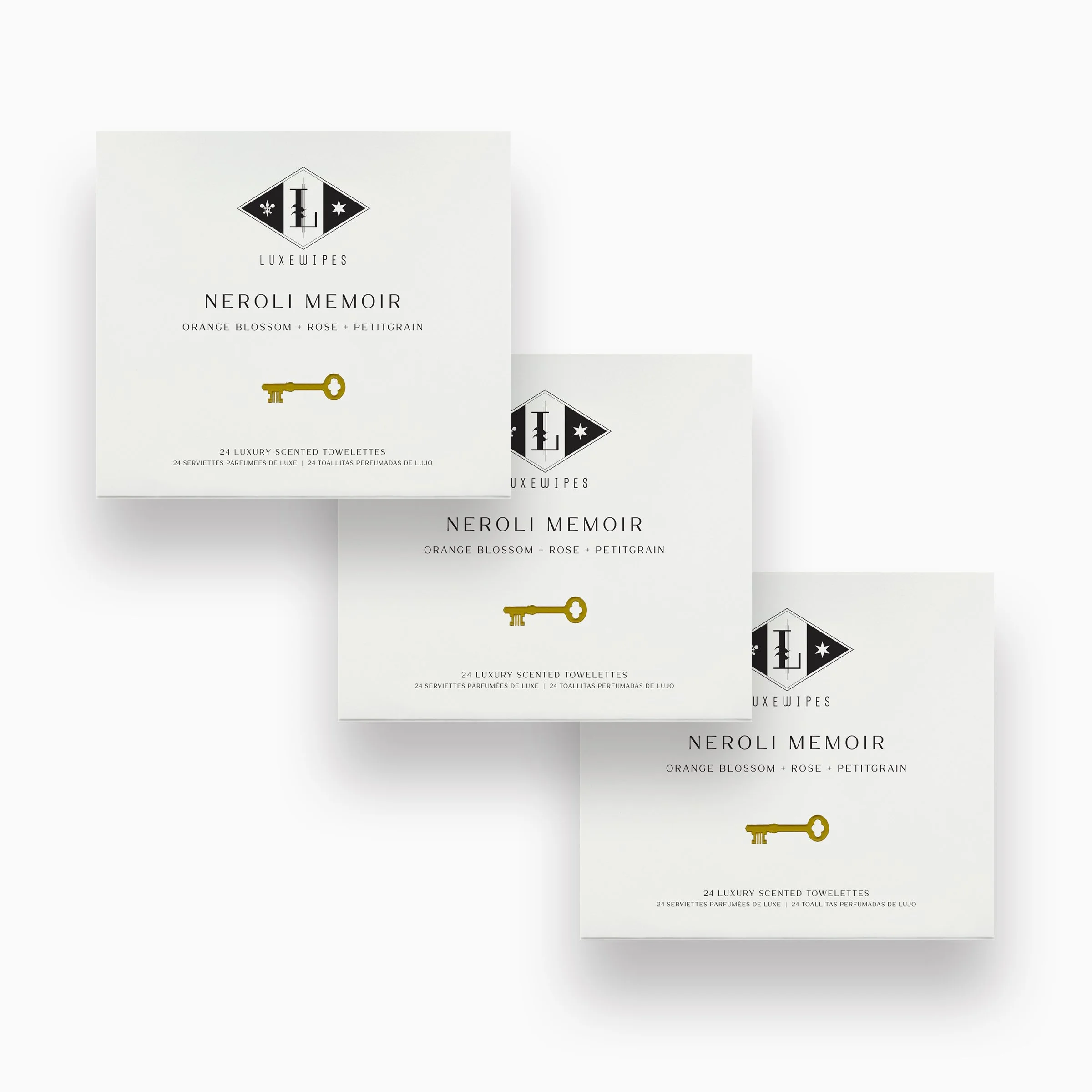 Front view of three LUXEWIPES Neroli Memoir boxes, each with 24 individually wrapped oxford-woven cotton wet wipes. An elegant fragrance, creating a unique hostess gift or for elevated self-care.