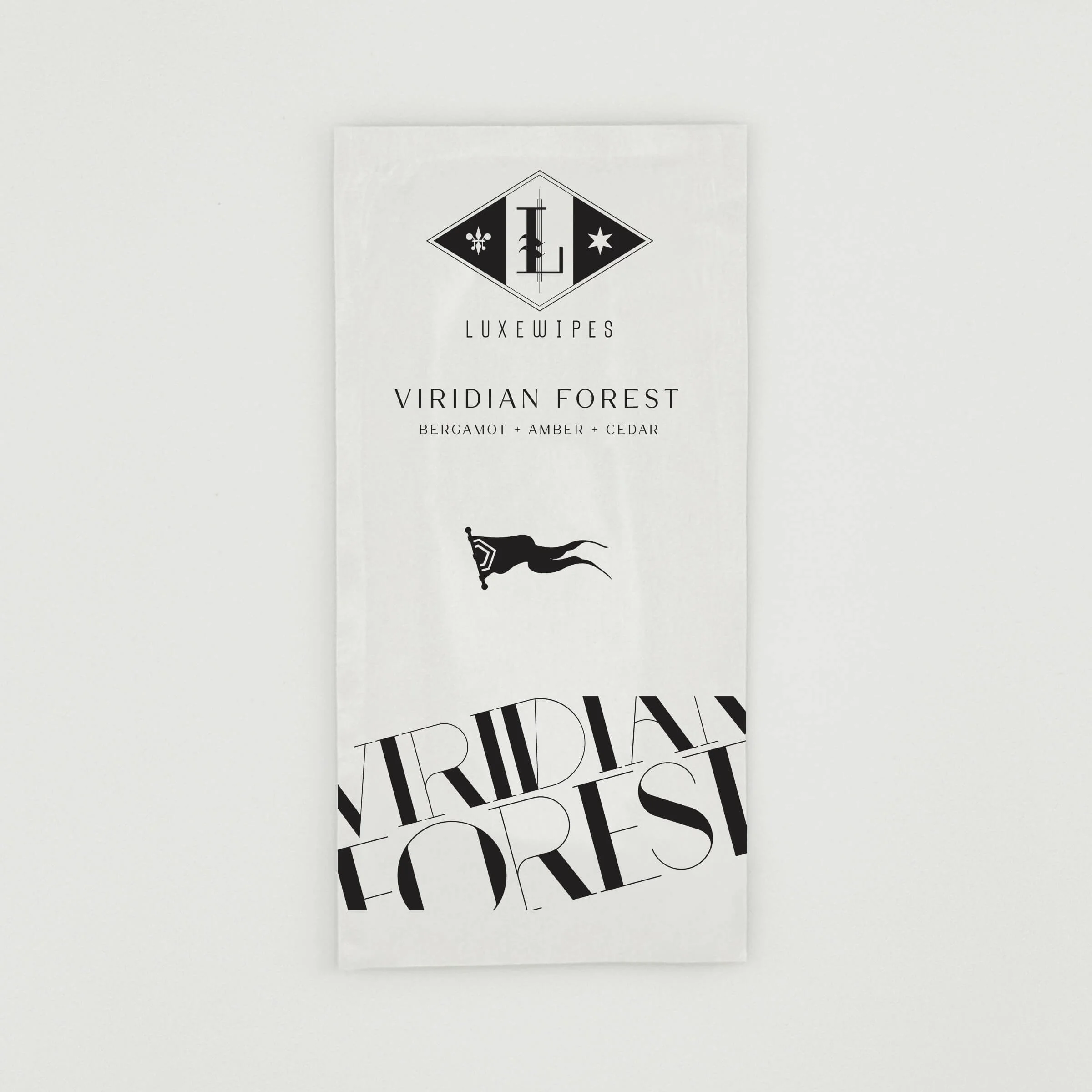 An individually wrapped LUXEWIPES Viridian Forest sachet, showcasing the portable luxury wipes available to mix, match, and select for your custom Fragrance Palette Trio box set.