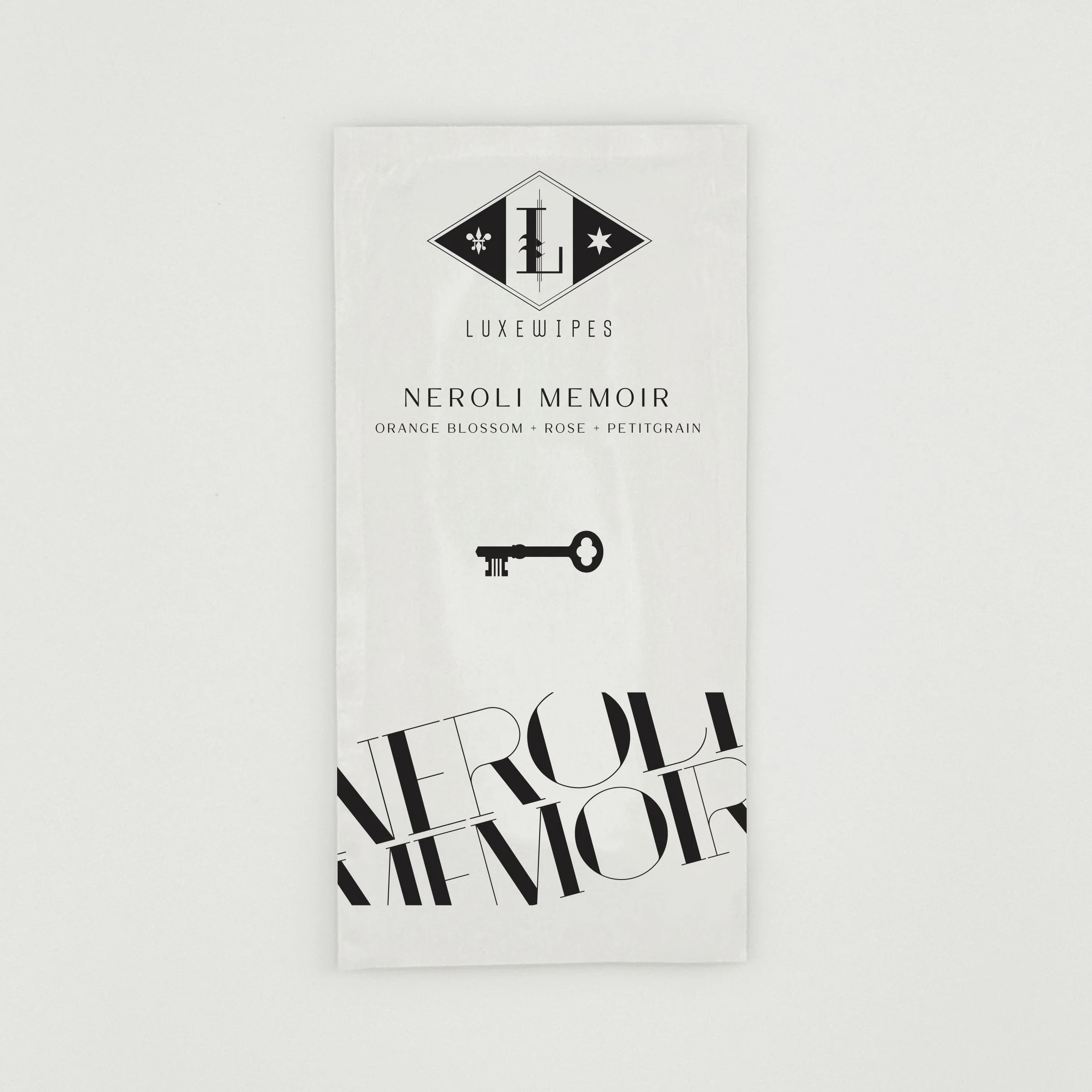 An individually wrapped LUXEWIPES Neroli Memoir sachet, representing the elegant, travel-ready luxury hand and face wipe selection for your custom Fragrance Palette Trio bundle.
