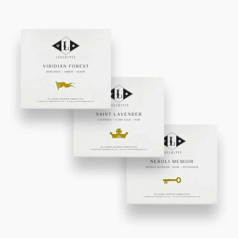 Front view of LUXEWIPES Viridian Forest, Saint Lavender, Neroli Memoir boxes, each containing 24 individually wrapped oxford-woven cotton wet wipes, providing a luxurious spa-like experience.