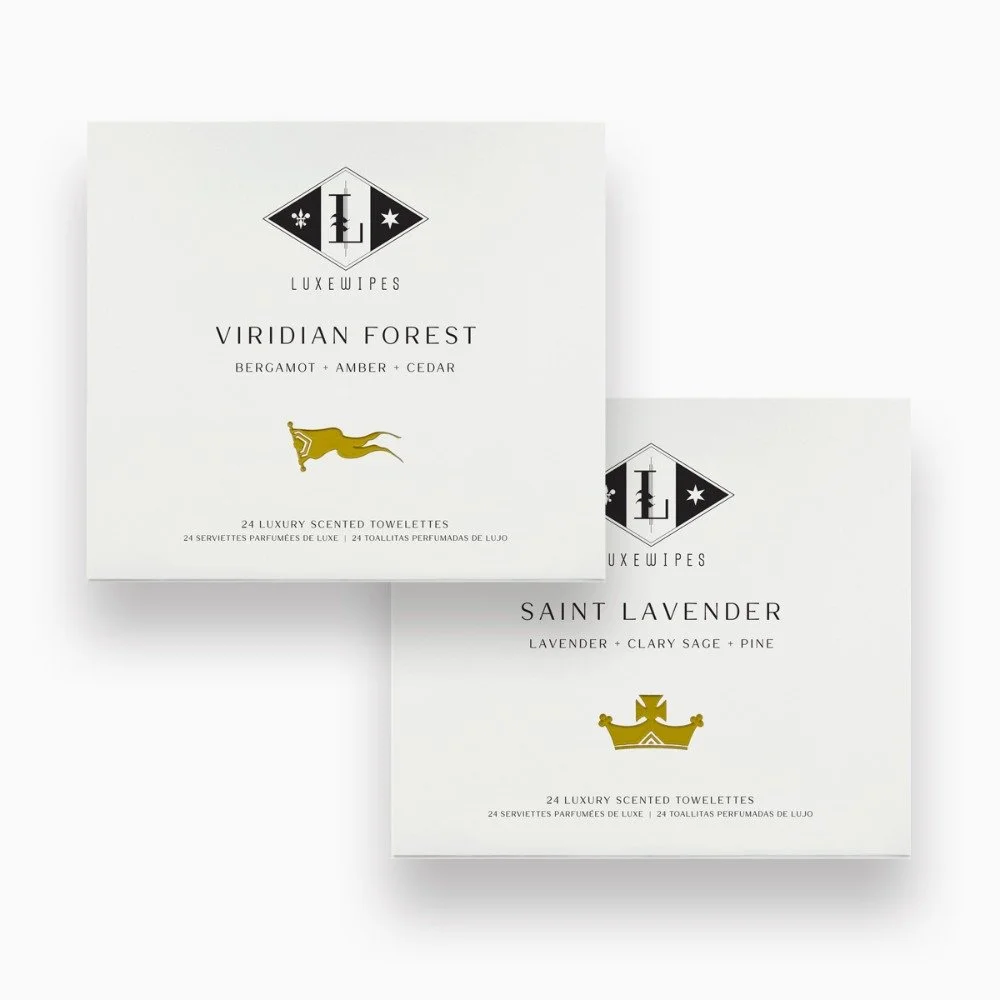 Front view of LUXEWIPES Viridian Forest box on top and Saint Lavender on bottom. 24 individually wrapped oxford-woven cotton moist towelette duo for an elevated, bespoke personal care experience.