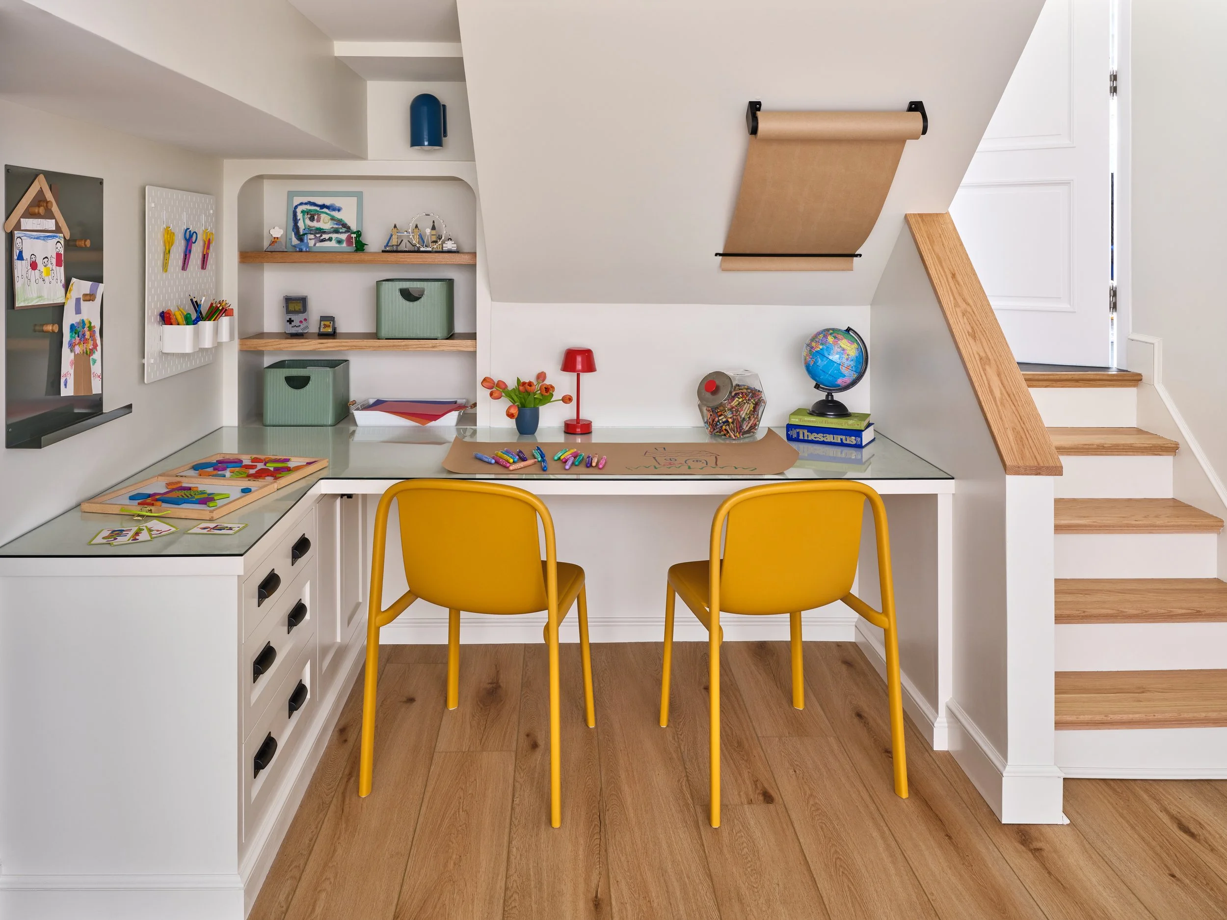 The project focused on the family's key priorities: ample storage for arts and crafts supplies, dedicated workspace, and areas to display their children’s creations. The result is a high-function, high-use nook.